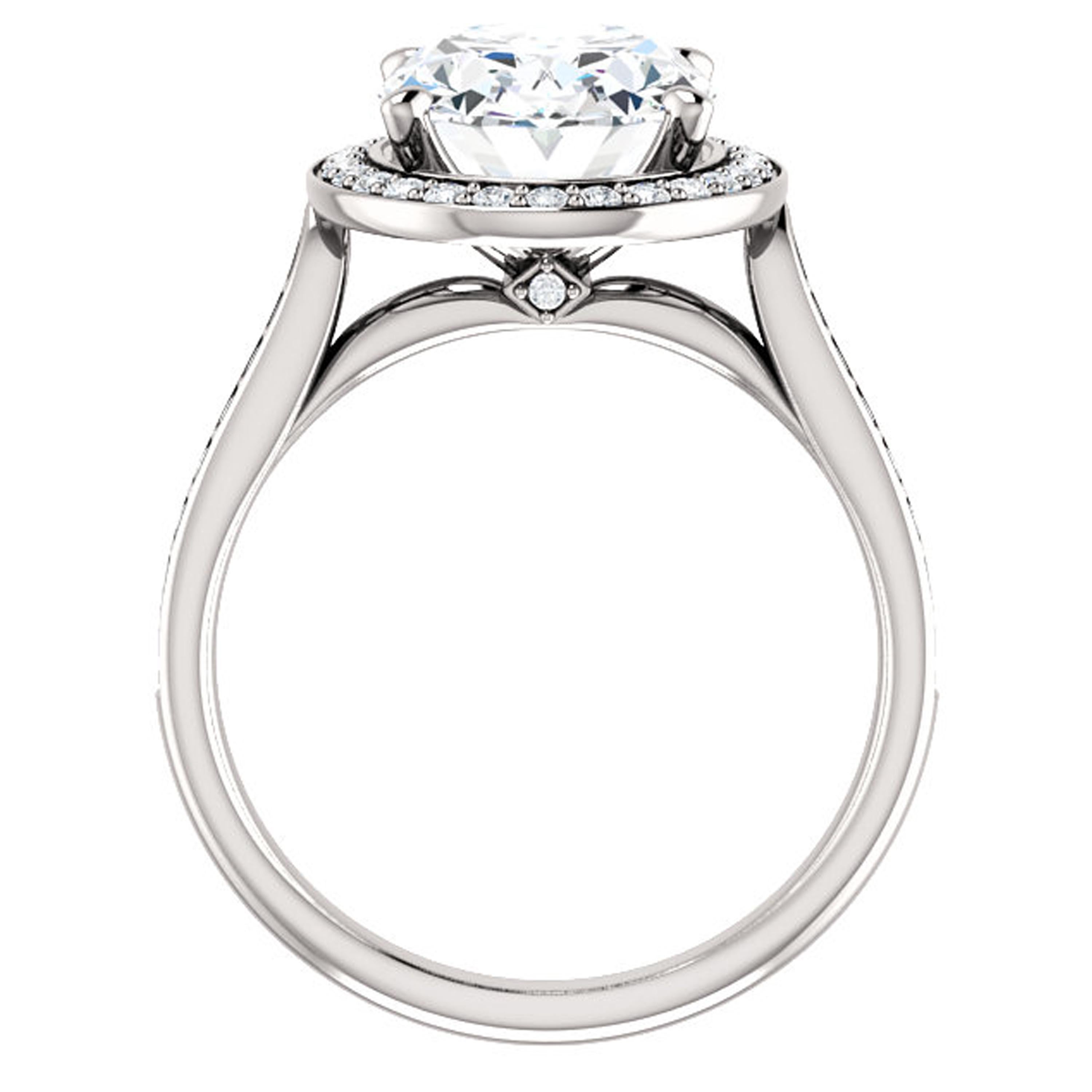 The arches of this cathedral style engagement ring rise up to reach the shimmering center Forever One oval moissanite center stone. Dazzling diamonds line the shank and surround the halo, amplifying the canter stone. 

Style No. :