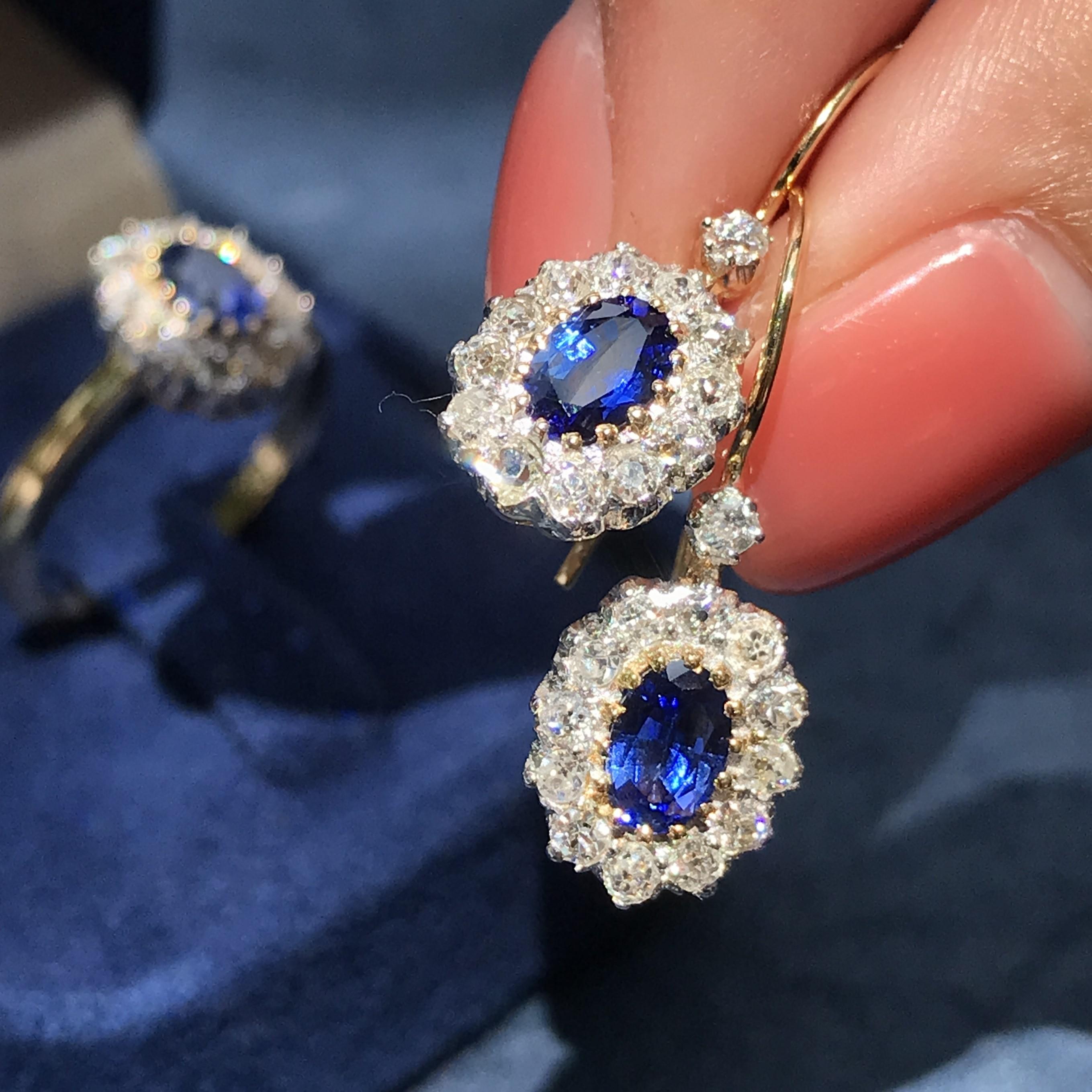 These classic and very versatile ear baubles, glisten in the centers with a pair of vibrant royal blue Ceylon sapphires enshrined in halos of round diamonds. Total diamond weight 0.91 carat. Match them with your favorite outfit to complete your