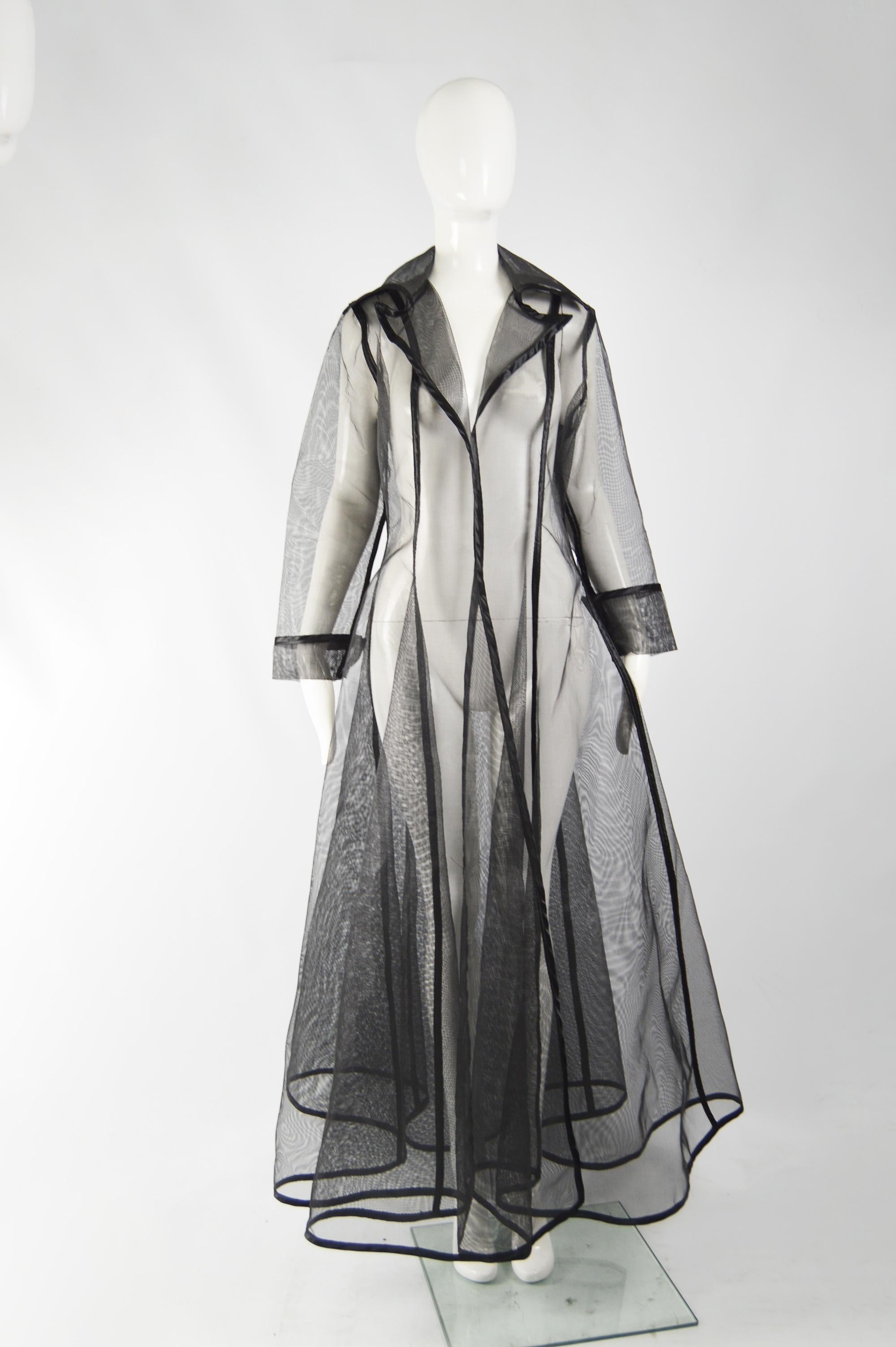 A dramatic and rare vintage see through maxi jacket from the 80s by iconic fashion designer, Catherine Coatney, known for her scupltural and bondage inspired designs. It is made from a mesh that is so structured that it almost stands up by itself,