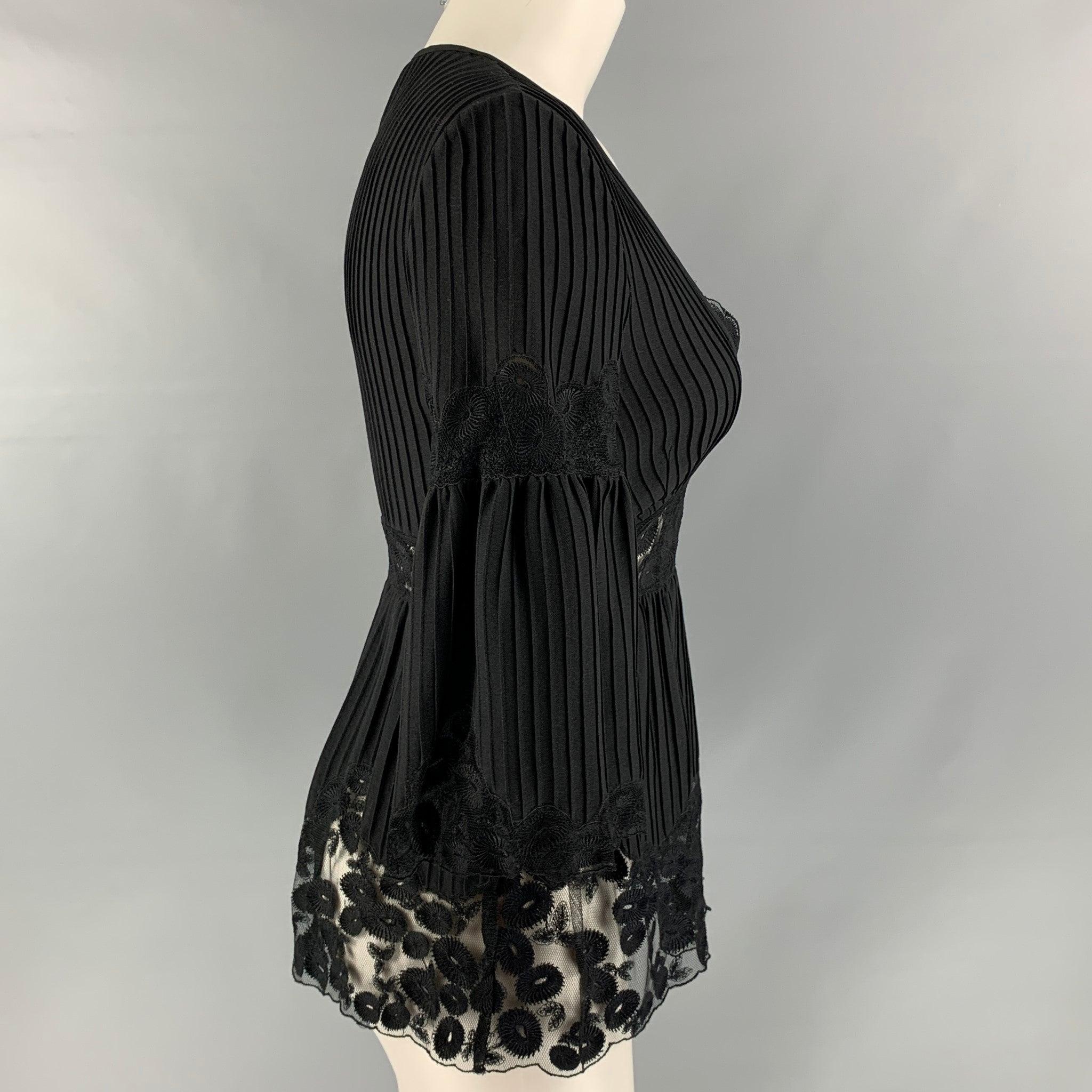 CATHERINE MALANDRINO long sleeve blouse comes in black wool and silk featuring a pleated detail, v-neck, and lace panels.Excellent Pre-Owned Condition. 
 

 Marked:  S 
 

 Measurements: 
  
 Shoulder: 15 inches 
 Bust: 34 inches 
 Sleeve: 17