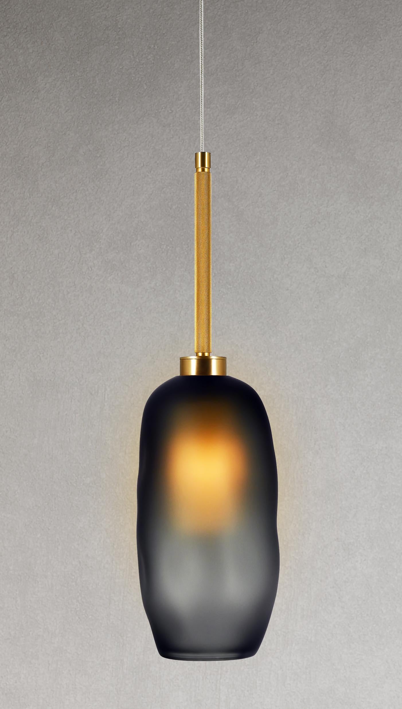 The Catherine can be displayed as a hanging pendant, wall sconce, or grouped in multiples. Our most versatile design also has a new, elevated look: a tubular oval glass diffuser that perfects the art of the soft glow. Balanced by the masculine edge