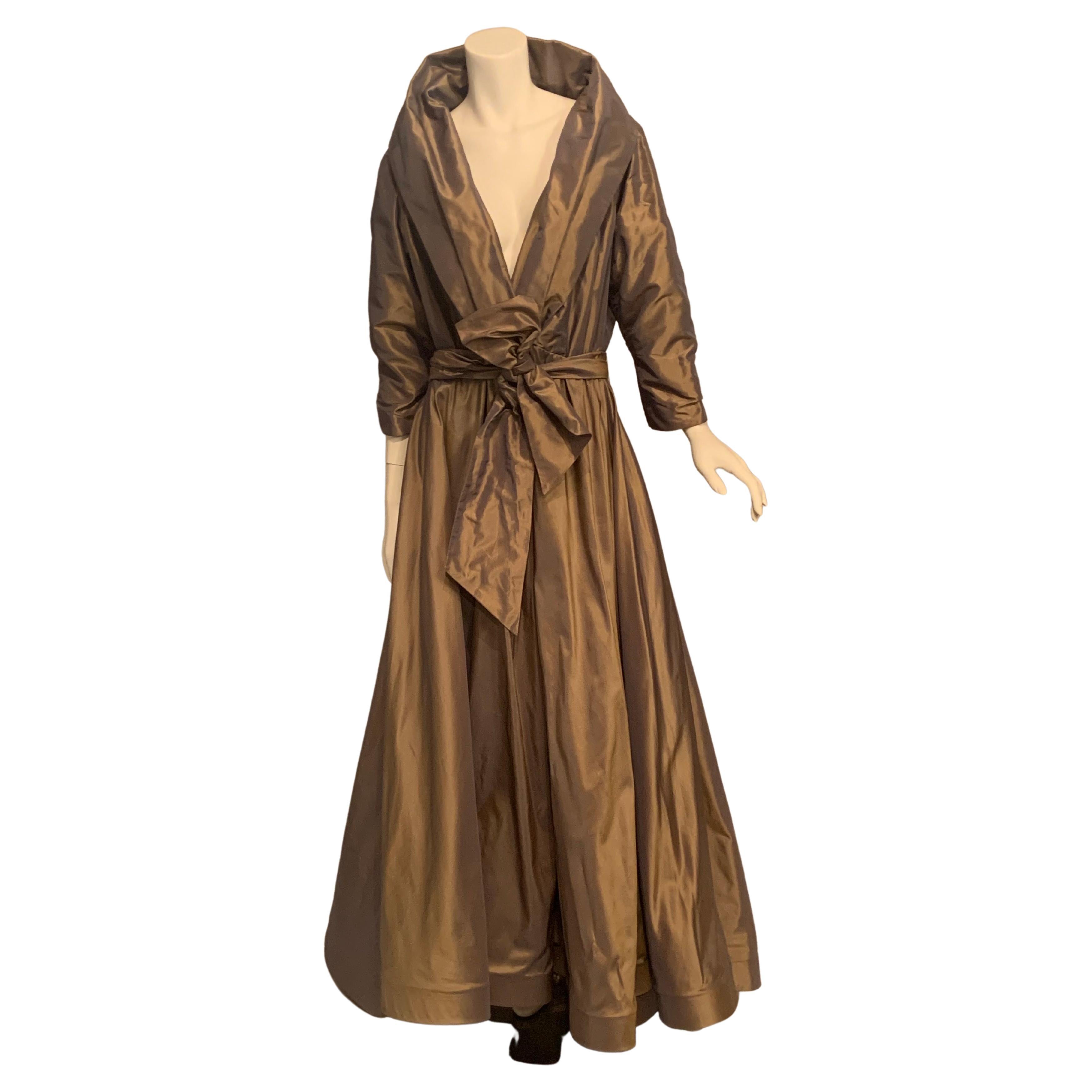 Catherine Regehr has chosen an unusual changeable silk taffeta for this evening dress.  The silk fabric appears to change color with the light and the movement of wearer.  This can be seen in the photos of the dress.  It has a generous shawl collar,
