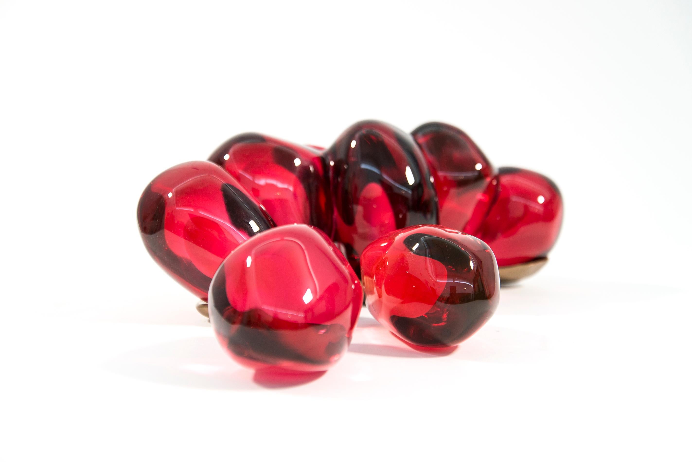 Amaranth and raspberry coloured glass sculpture, referencing the idea of the sensual nature of a pomegranate, the seeds nestled in a bronze base and casing. Vamvakas Lay uses pomegranate imagery, often combined with bronze, to explore the ancient