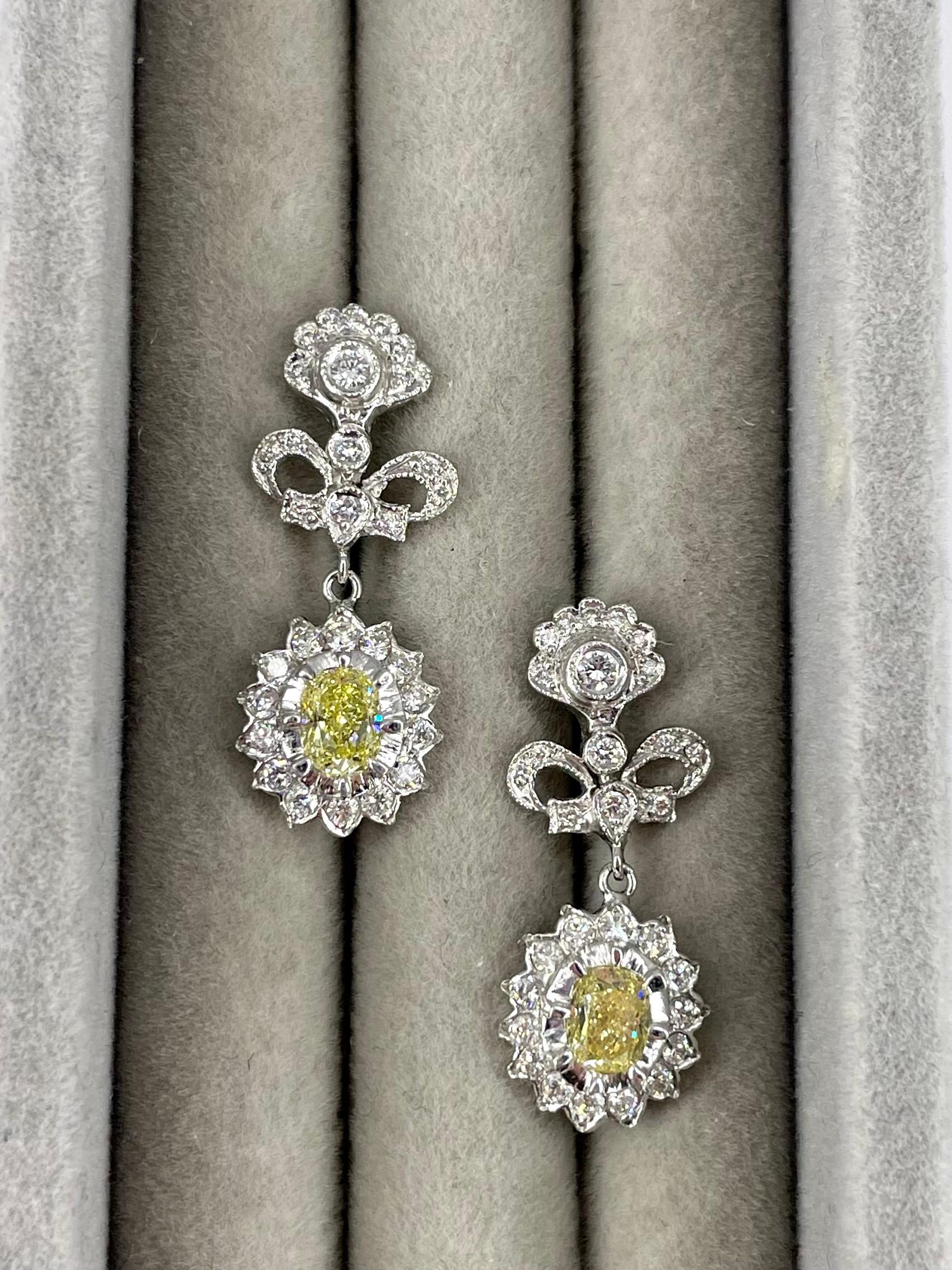 These charming antique style earrings by Cathy Carmendy are a sweet, feminine design full of unique details. The craftsmanship of these earrings makes them a truly special addition to any jewelry collection. The two fancy yellow oval diamonds total