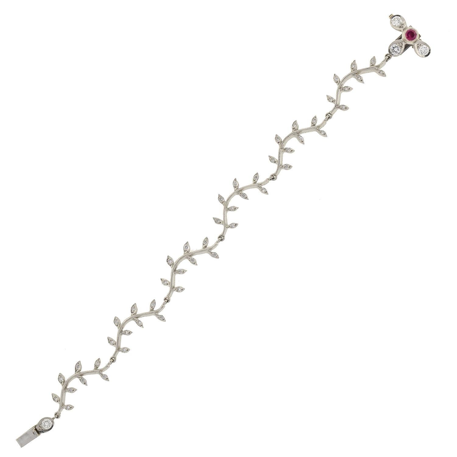 A contemporary diamond and ruby bracelet from legendary maker Cathy Waterman! This lovely piece is made of platinum and has a feminine flower and vine design. The bracelet features 6 long branch-like links, each encrusted with sparkling diamonds