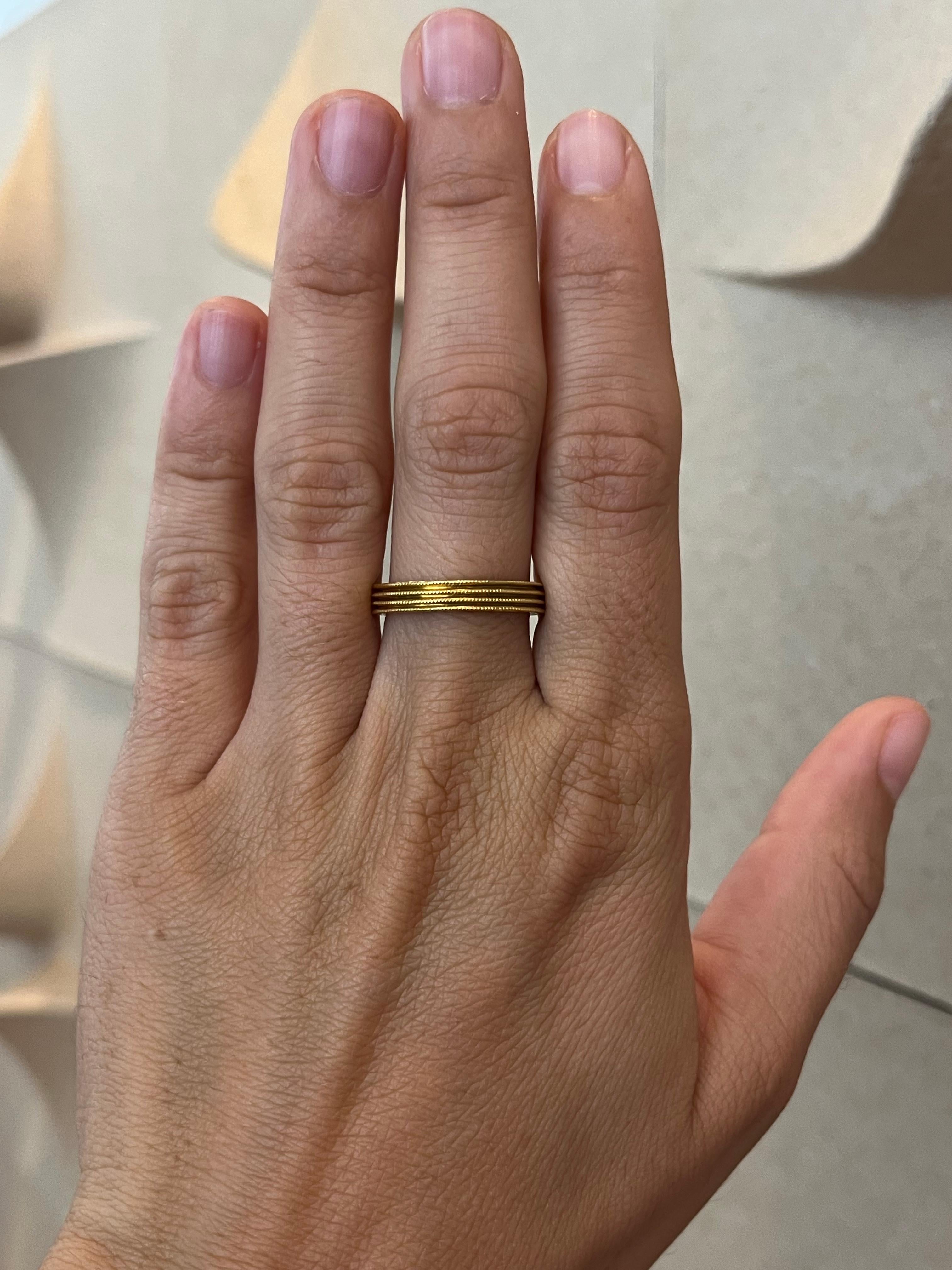 From the Bracken Jewelers estate fine jewelry collection in Santa Monica, California. This signed Cathy Waterman grooved gold wedding band provides visual and tactile delight from the beaded milgrain on the ridges to the rich color of the 22K yellow