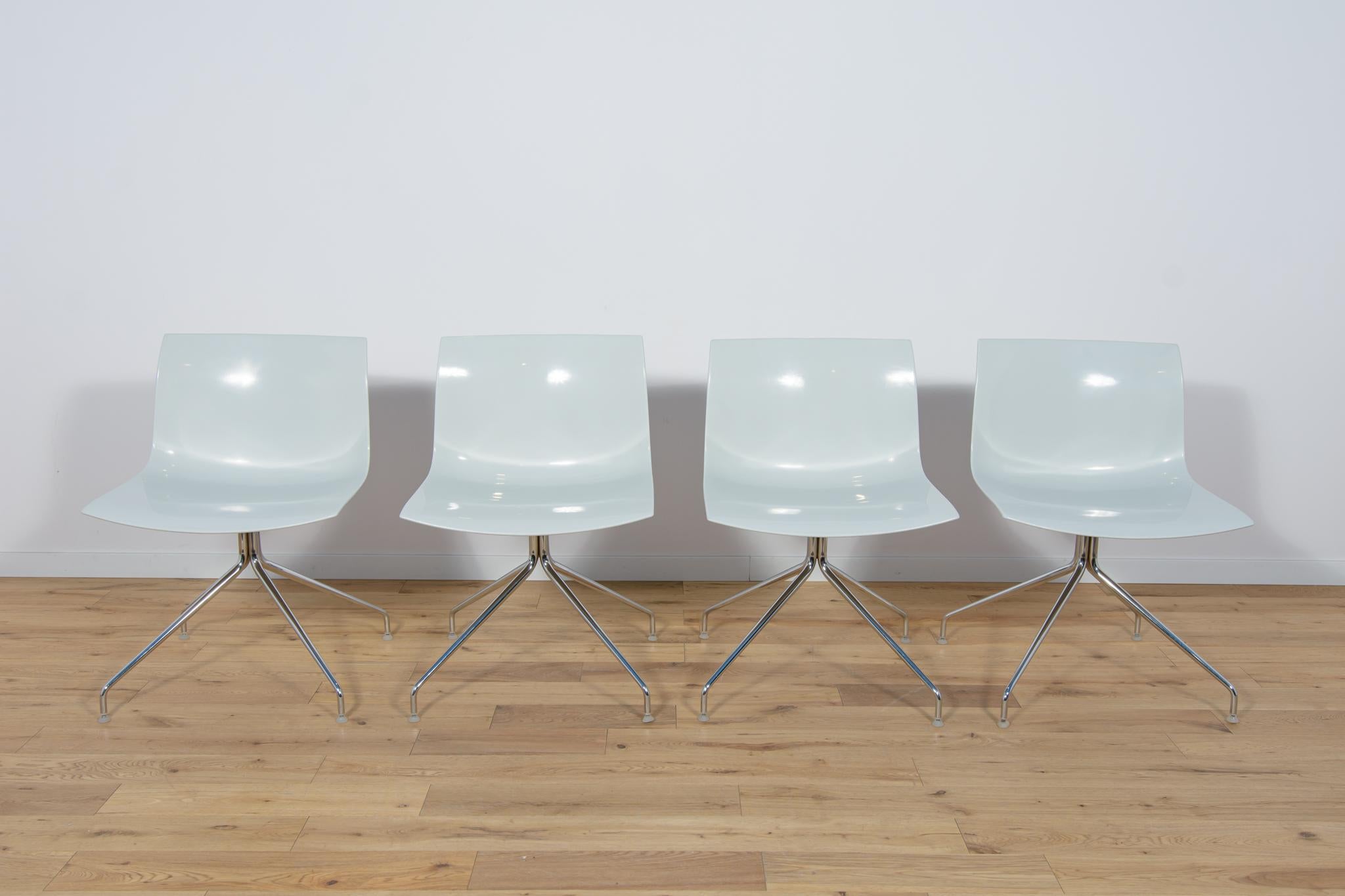 Chairs were designed by Lievore Altherr Molina, produced by Arper at the beginning of the 21st century in Italy. The armchairs have chrome swivel legs. Chrome elements have been polished. Ergonomic seats made of strong plastic. The chairs have