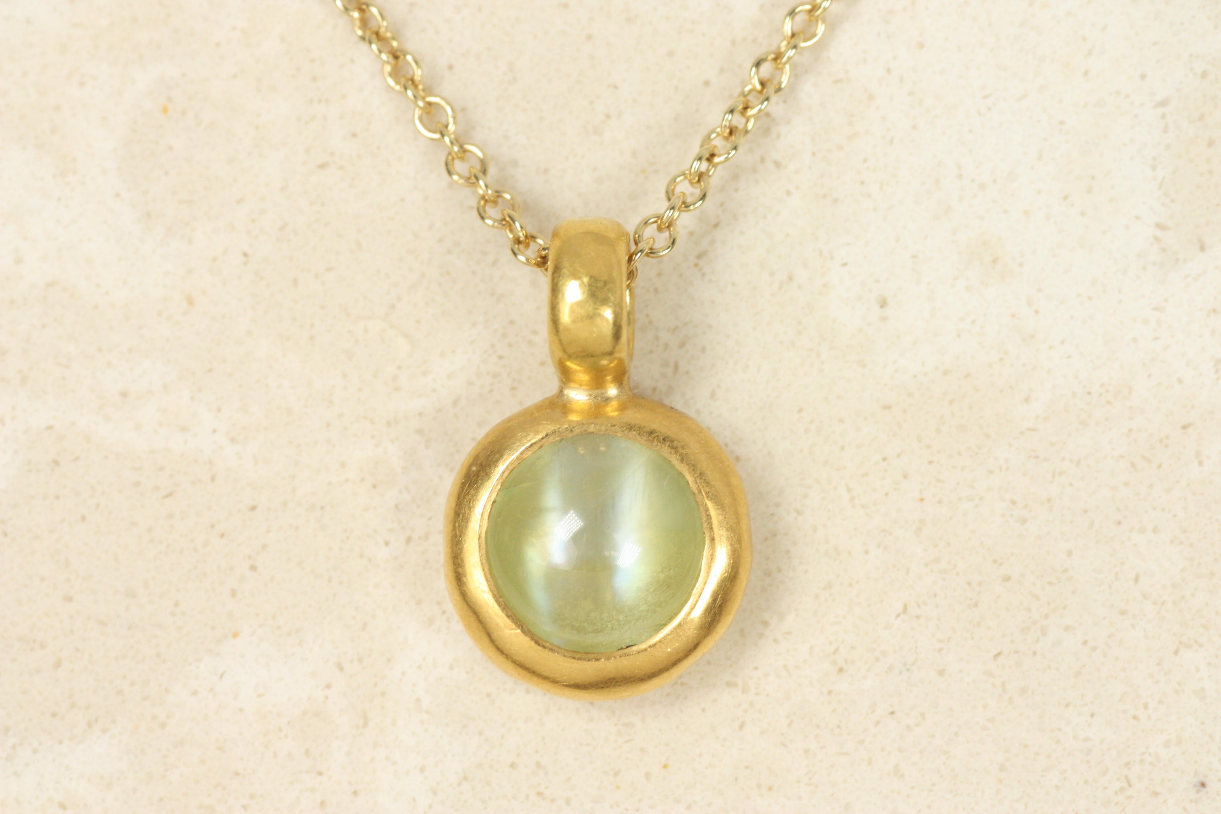 This cat's eye bezel charm pendant hangs beautifully on both short and long chains, on its own or layered with other necklaces. Crafted in 22K yellow gold, this is a one-of-a-kind piece, made by Bracken Jewelers in Los Angeles, California.

Chain