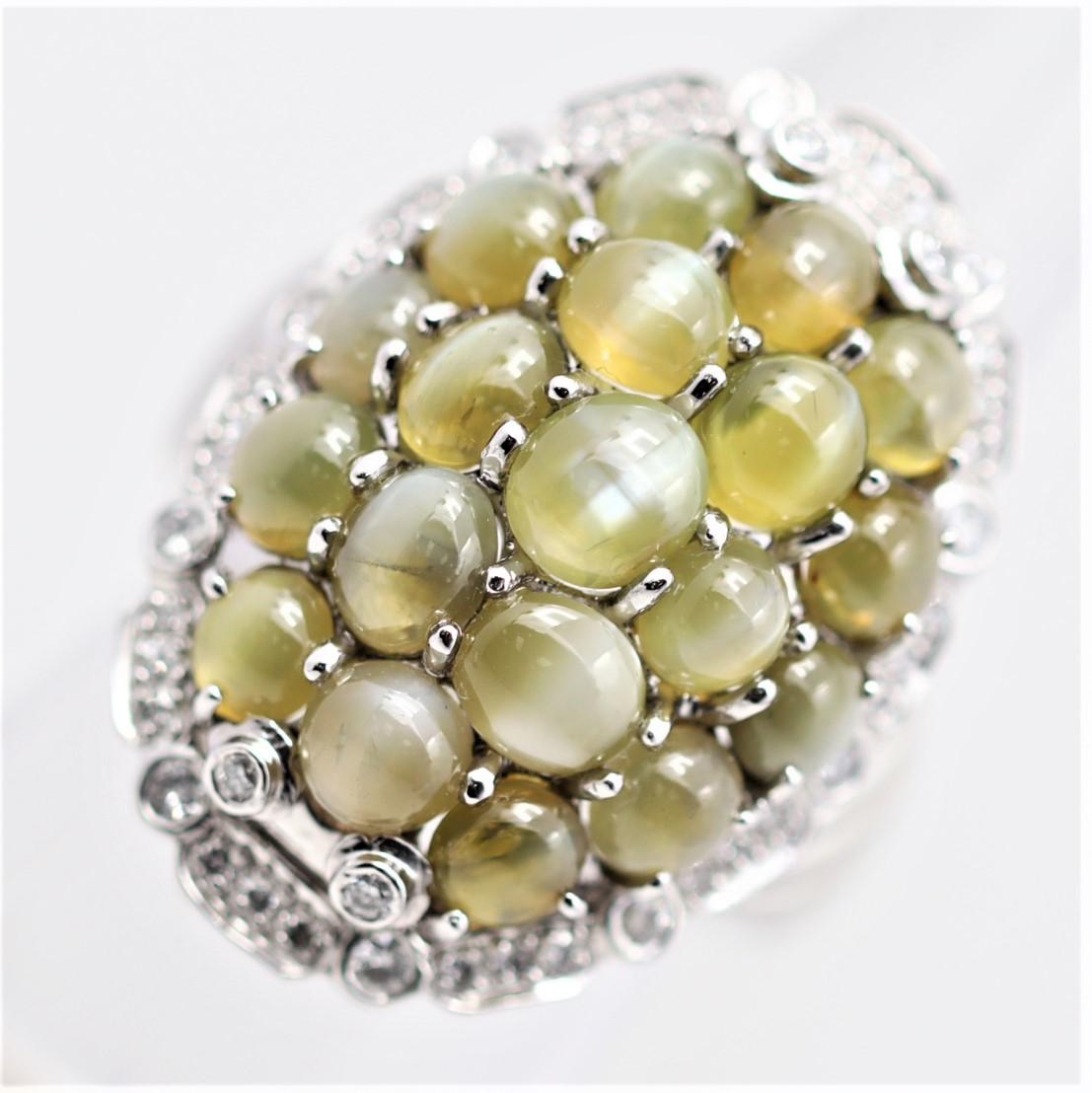 A fun cocktail ring featuring 19 cats eye chrysoberyl cluster set next to each other, which weigh a total of 10.30 carats. It is further accented by 0.51 carats of diamonds which add sparkle and brilliance to the ring. A large ring hand-fabricated
