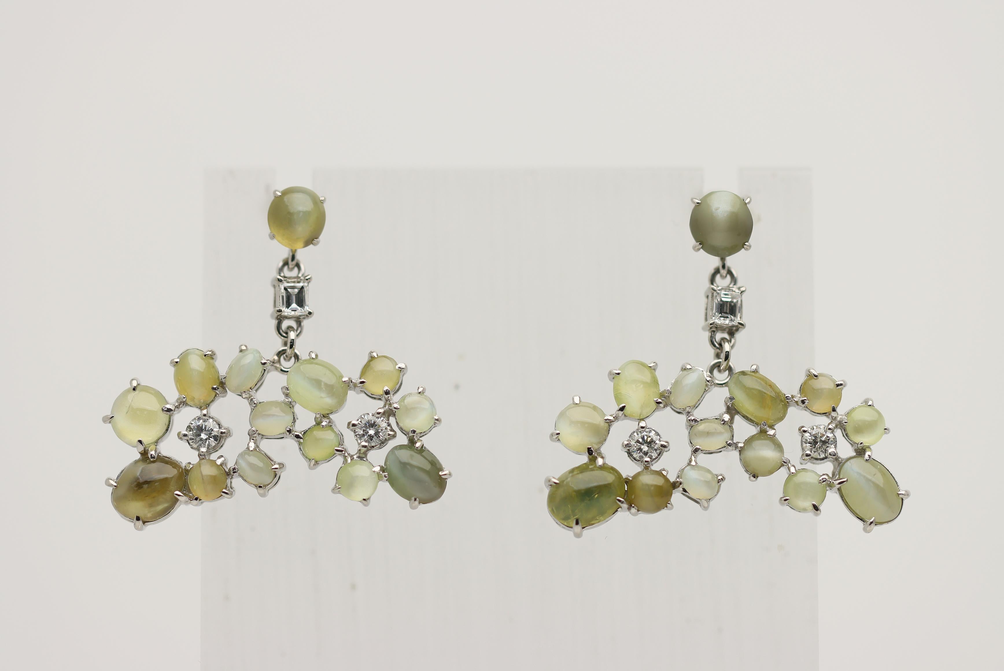 A unique, stylish, and fine pair of platinum drop earrings. They feature 26 cat eye chrysoberyls which weigh a total of 18.59 carats. Each stone has its own chatoyant eye giving the earrings a far-out look. It is complemented by 0.81 carats of round