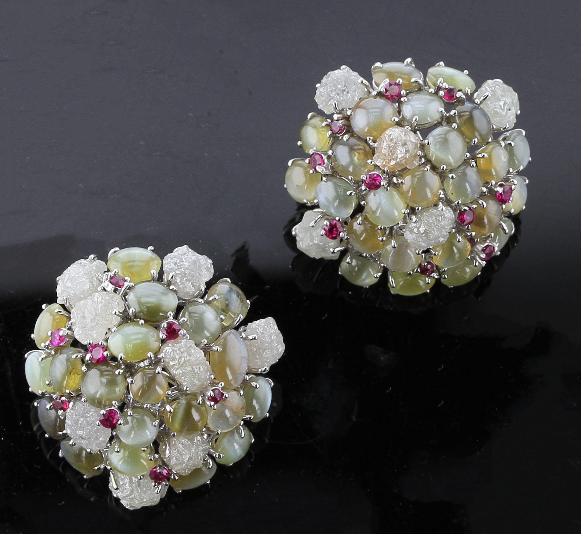 A stunning pair of earrings with Cat’s Eye Chrysoberyl (appx. 28 cts), Rubies (0.60 cts), and Rough Diamonds (31 cts) mounted in 18K White Gold. Diameter: 1.25”