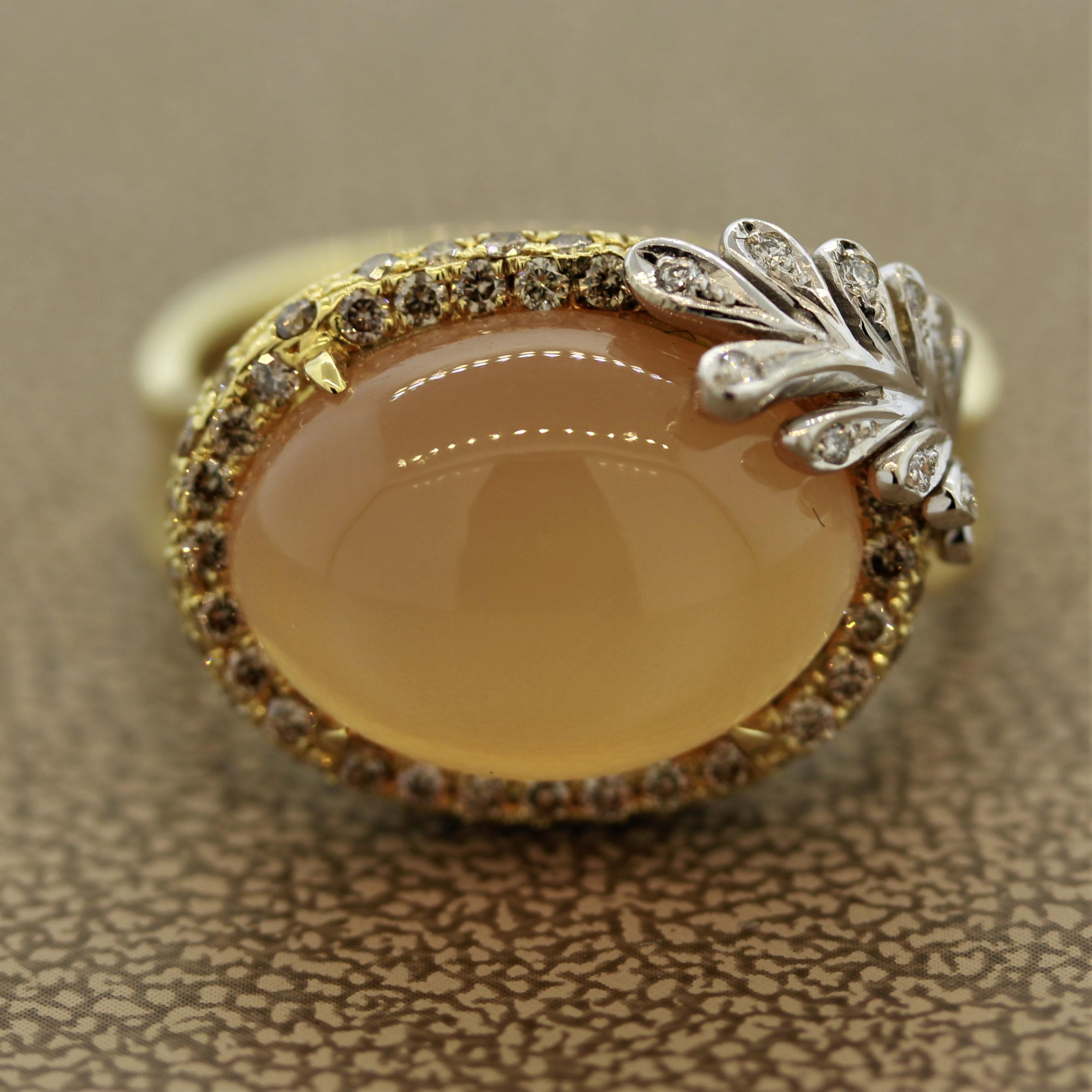 A lovely soft orange moonstone ring out of a fairytale. The moonstone weighs 8.69 carats and has excellent adularescence which makes it appear that light is rolling of the surface of the stone (a unique phenomenon of moonstones). Adding to that is