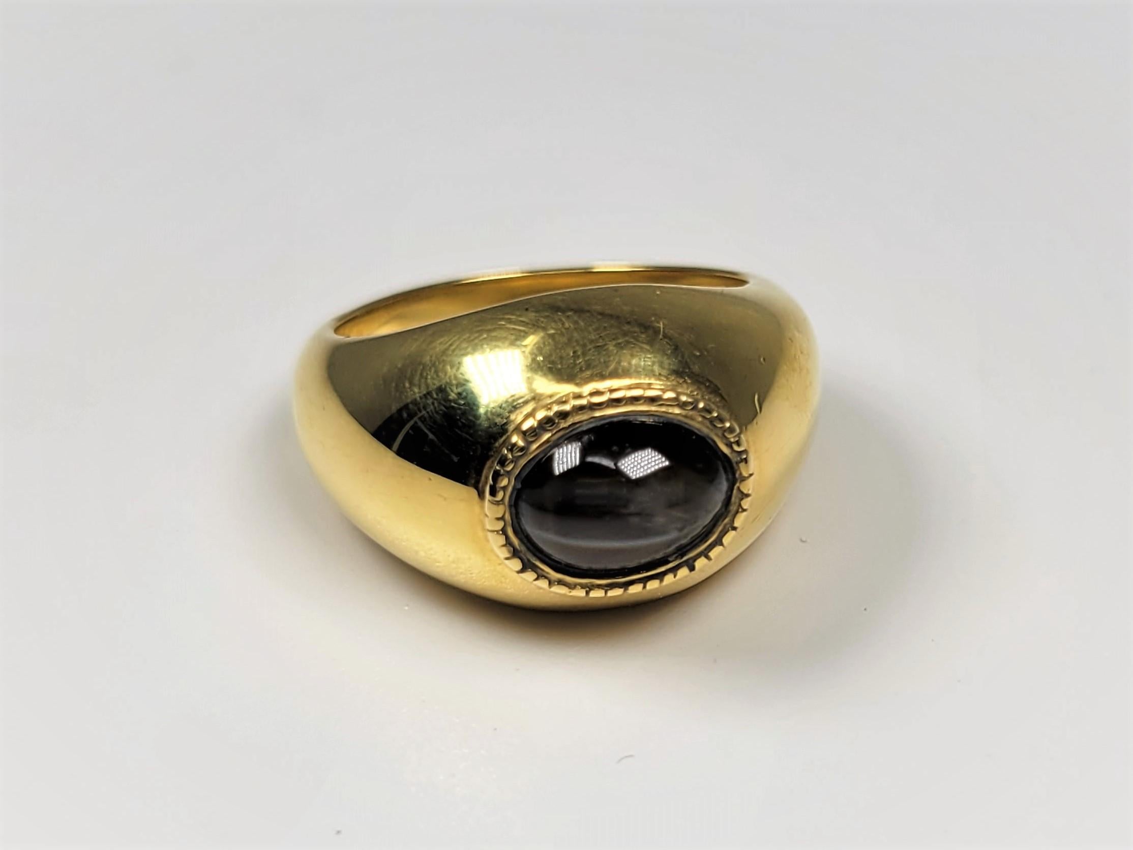 Mesmerizing 2.12 carat cabochon Cat's Eye set in a polished 18 karat gold ring.  This stone is accompanied by a Stone Group Laboratory Identification and Origin Report stating 