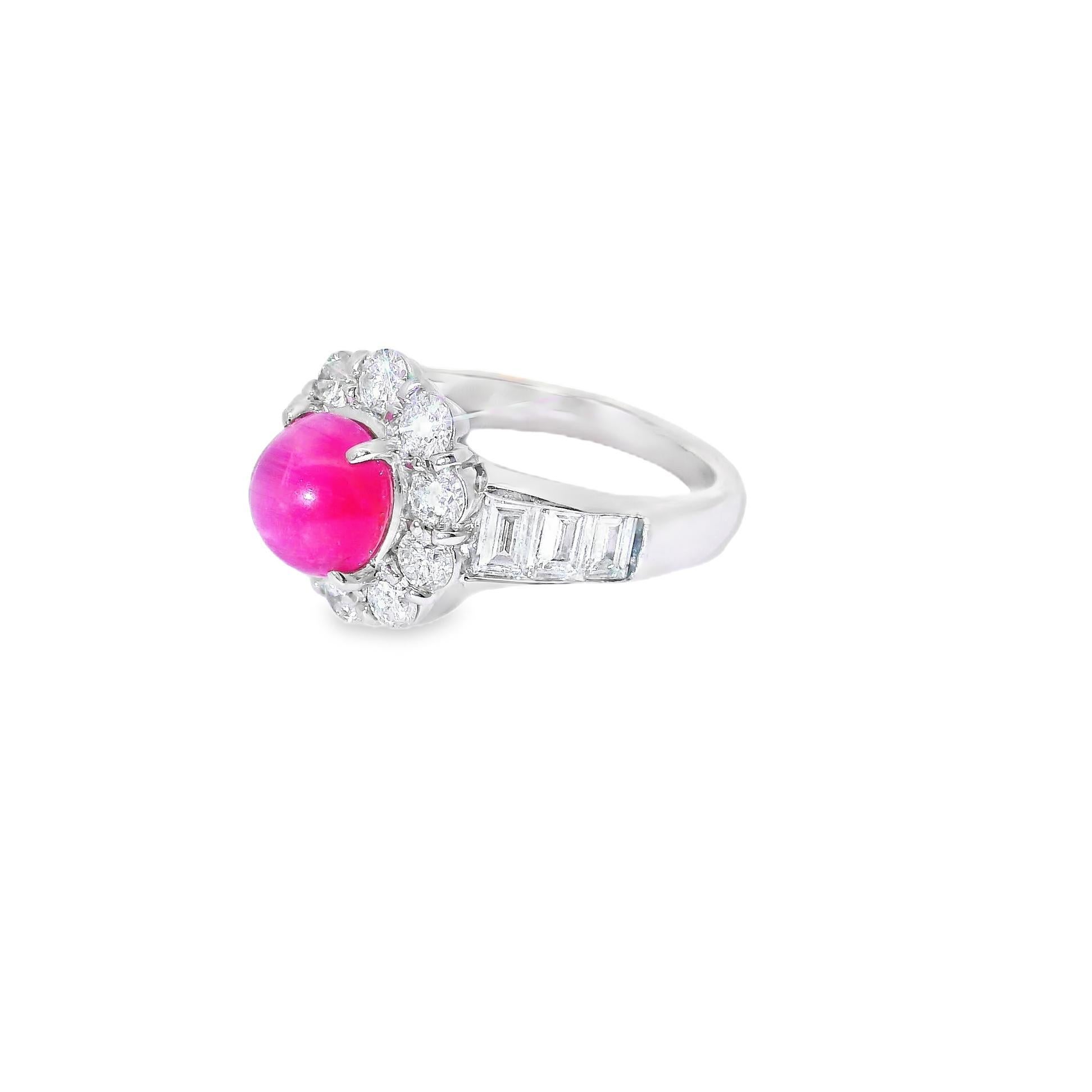 A chic and elegant platinum ring featuring a special pink tourmaline with a rare cats eye phenomenon. The tourmaline has a rich pink color and a strong cats eye, asterism, when a light hits the top of the stone. It is complemented by 1.53 carats of