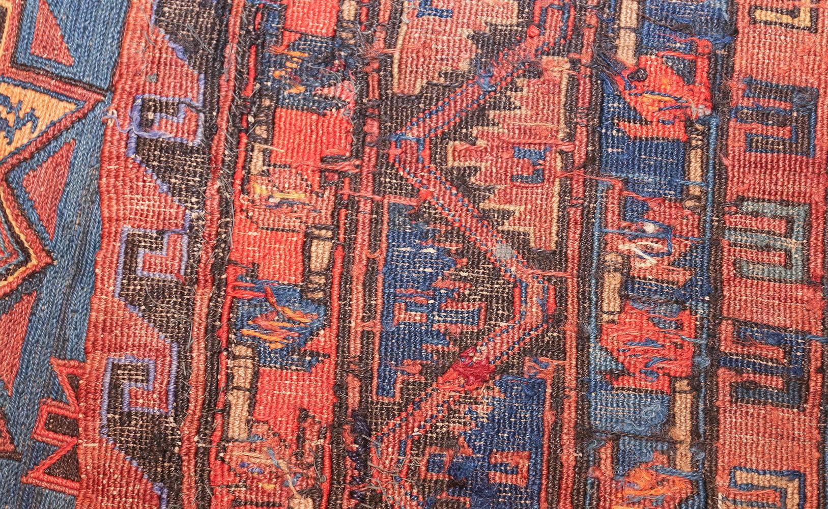 Antique Tribal Soumak rug, country of origin: Caucasus, circa early 20th century. Size: 6 ft 10 in x 11 ft 7 in (2.08 m x 3.53 m)

By using strong points of red and blue, the artist is able to convey a clear sense of opulence and luxury in this