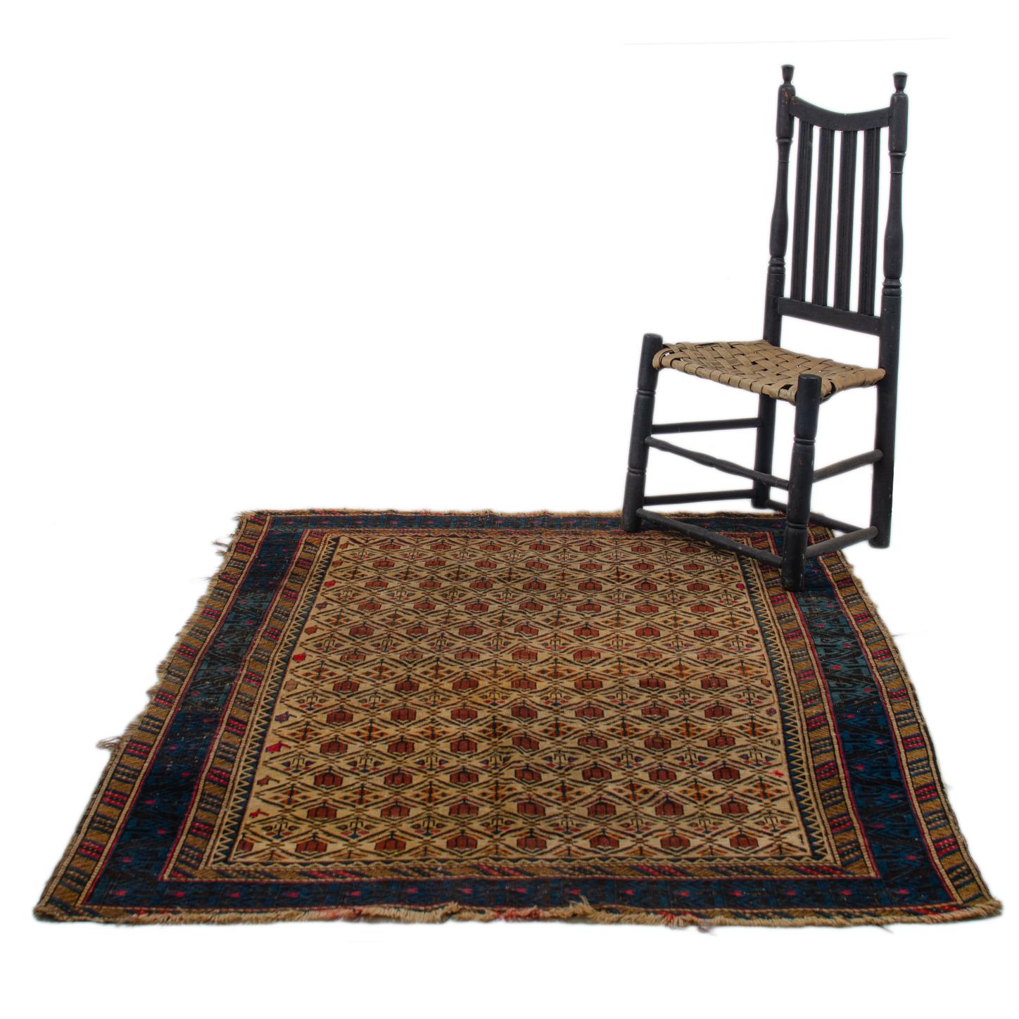 An antique Daghestan rug, circa 1900.

Repeating rows of red tulips and flowers on ivory ground.  Blue and black lattice main border within crosshatch borders.  

4’2” by 5’5” (50 by 65 inches)

