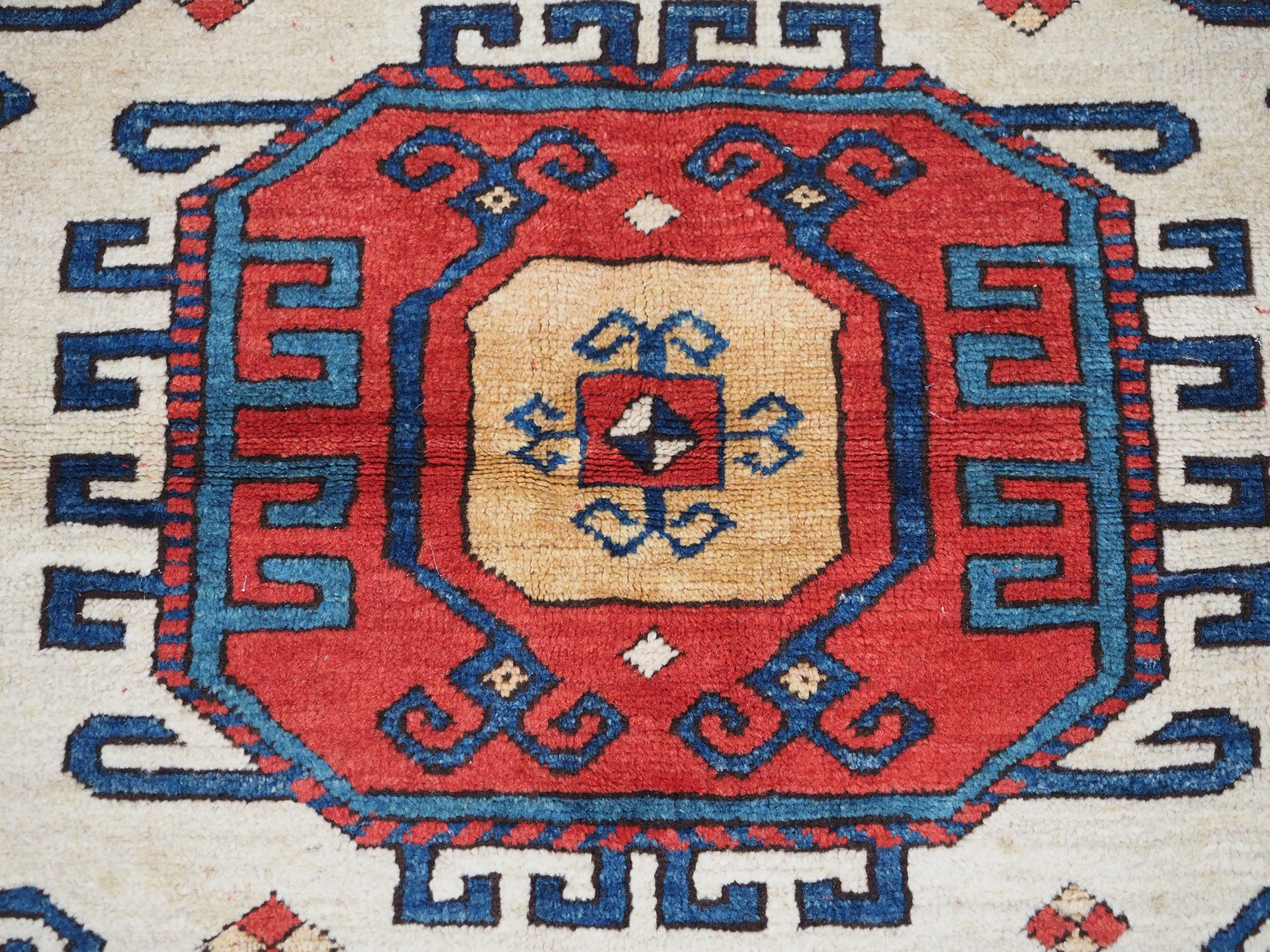 Caucasian Karachov Kazak style rug of classic design on a red ground For Sale 6