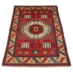 Retro Caucasian Karachov Kazak style rug of classic design on a red ground