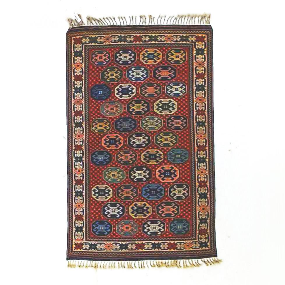 A Caucasian Kazak oriental rug offers wool construction with repeating design of medallions with stylized crabs, 20th C

Measures - 72