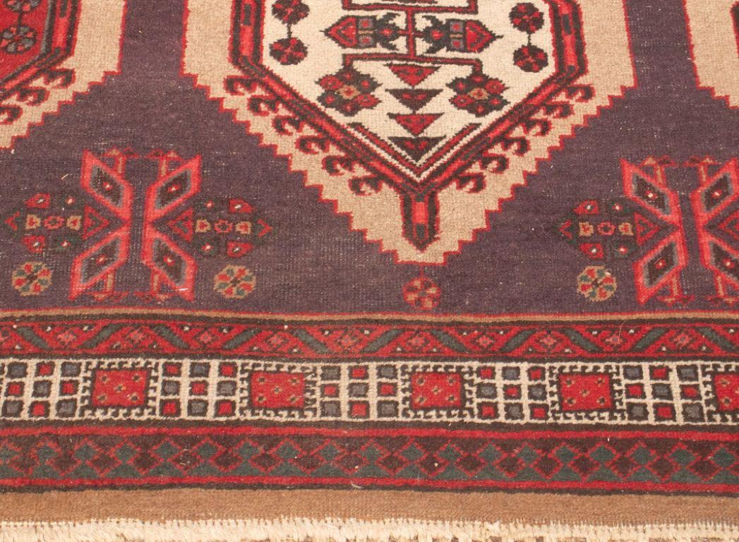 Caucasian Kazak wool rug, with a repeating geometric motif of medallions. 

Dimensions: 10' 7