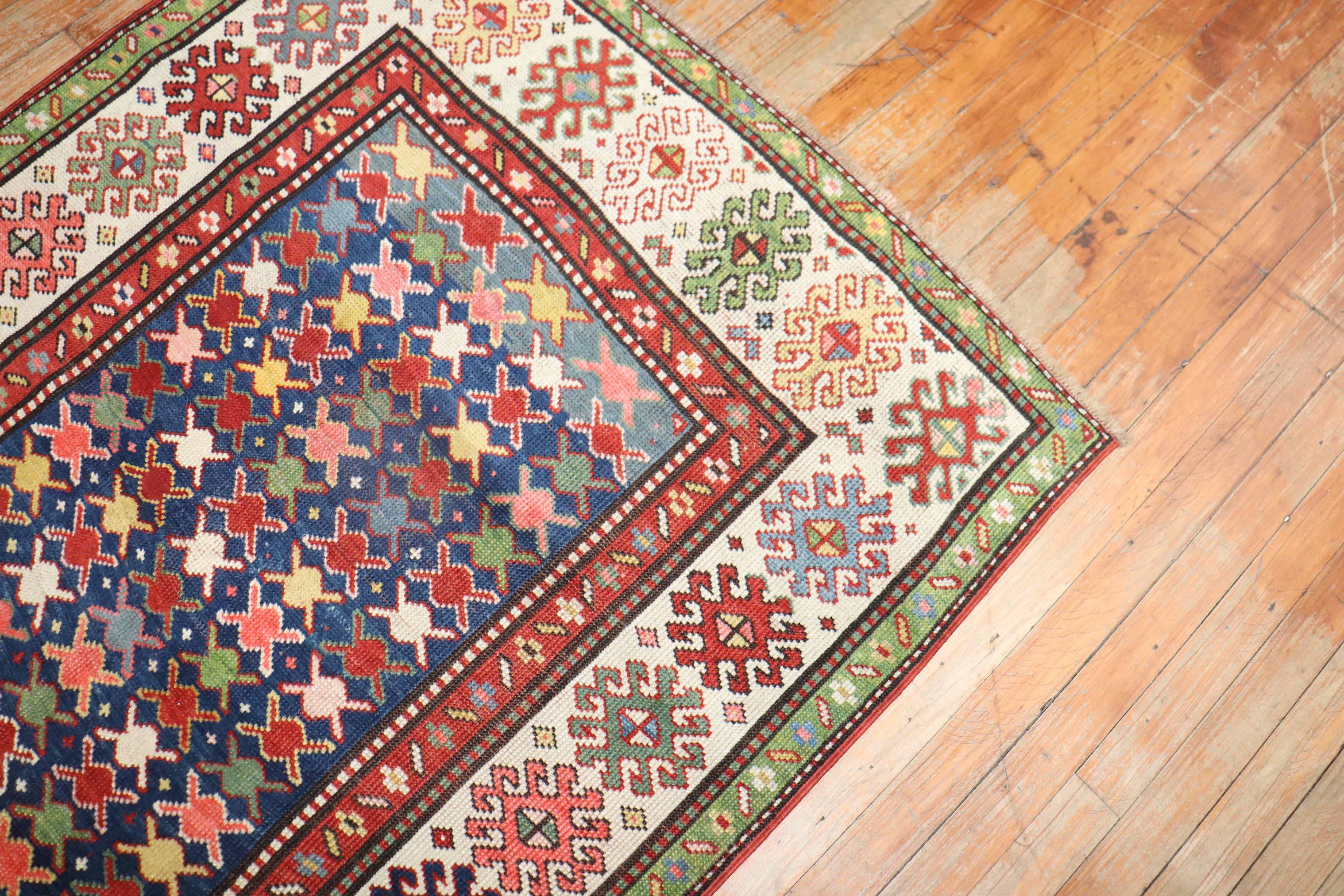 An early 20th century high decorative Caucasian Kuba runner with a colorful repetitive design on a navy color field

Measures: 3'4'' x 7'6''.