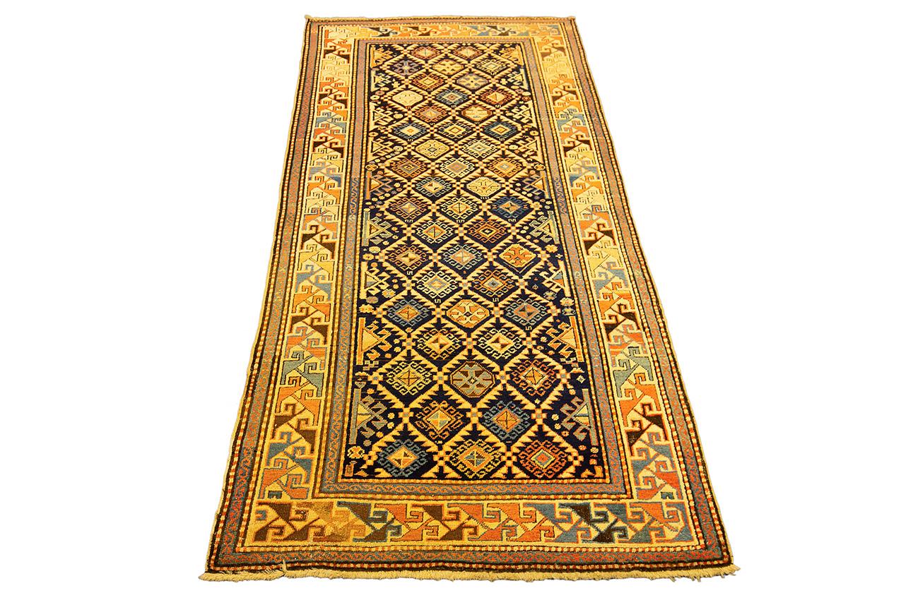 This antique Caucasian runner named Akstafa, hand-knotted in the 19th century and measuring 205 × 97 cm (6′ 8″ × 3′ 2″) was made by woolen fleece on woolen warp and weft. The Akstafas, due to the soft and fluffy fleece and the splendid geometric