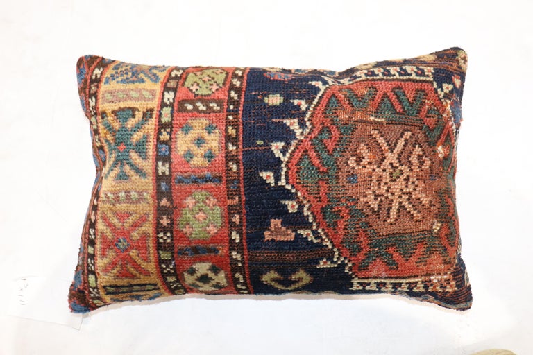 Pillow made from an early 20th century Antique Cucasian rug. Zipper closure and poly-fill provided.

Measures: 15'' x 23''.