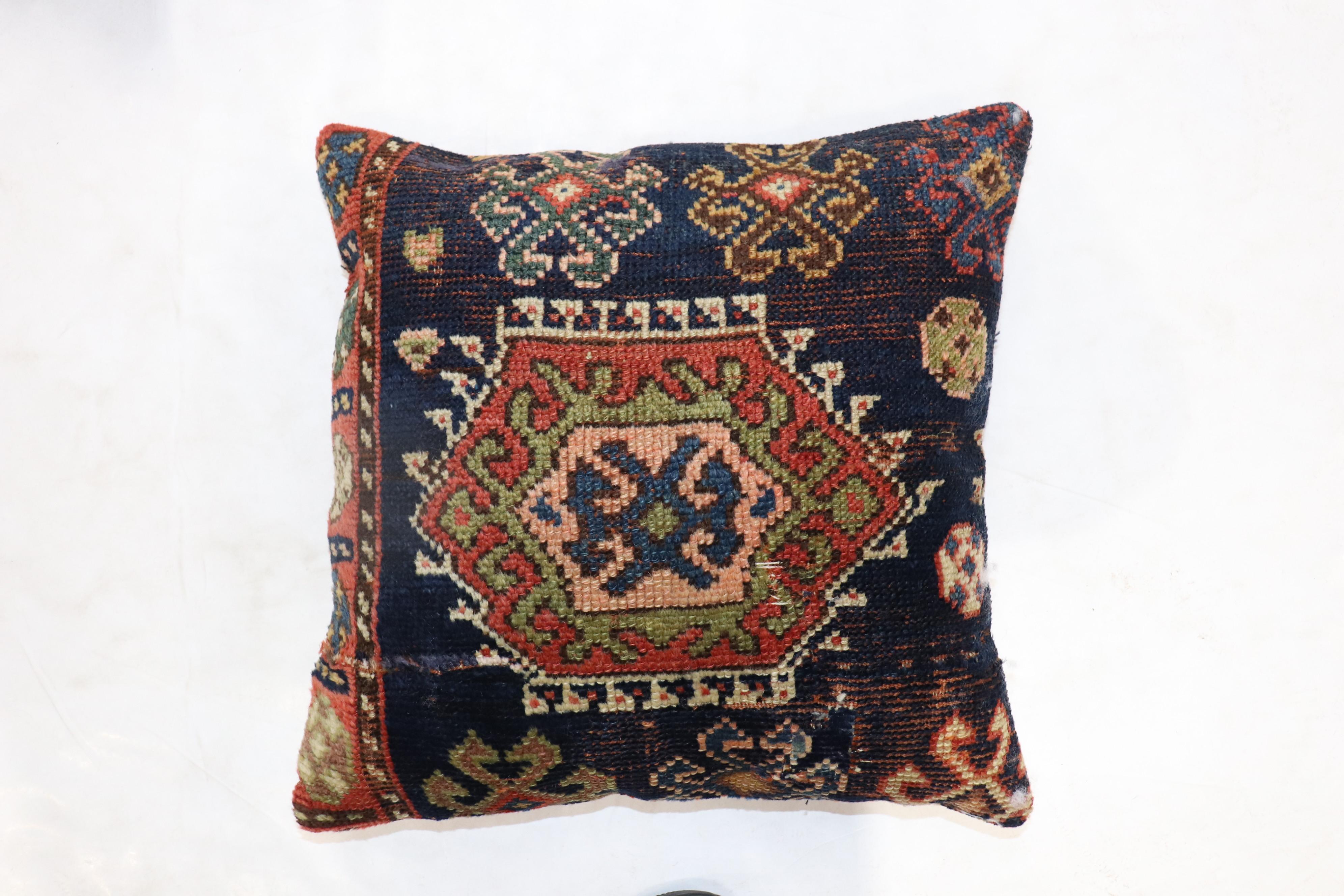 Pillow made from an early 20th century Antique Cucasian rug. Zipper closure and poly-fill provided.

Measures: 19'' x 20''.