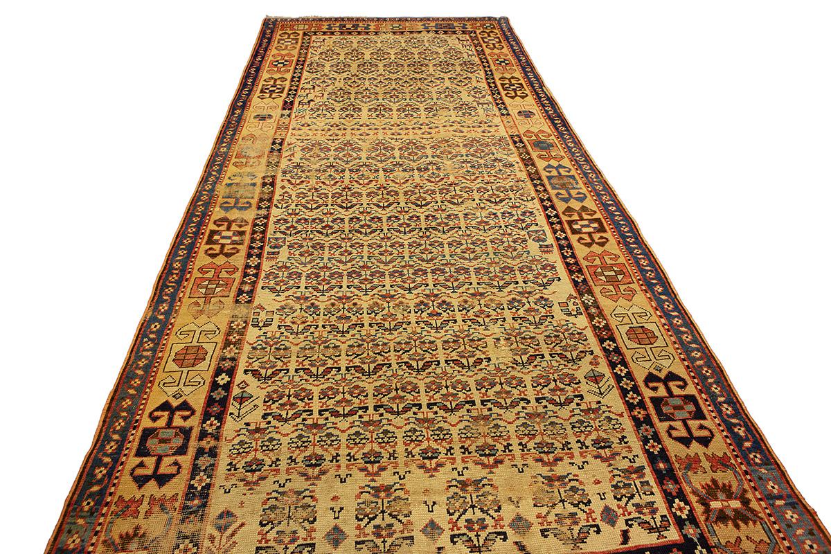 This exceptional Caucasian Shahsavan all-over design carpet is a rare example of Kalleh-size tribal weaving from the Caucasus, showcasing a highly intricate and symmetric floral pattern across its entire field. The main field is filled with