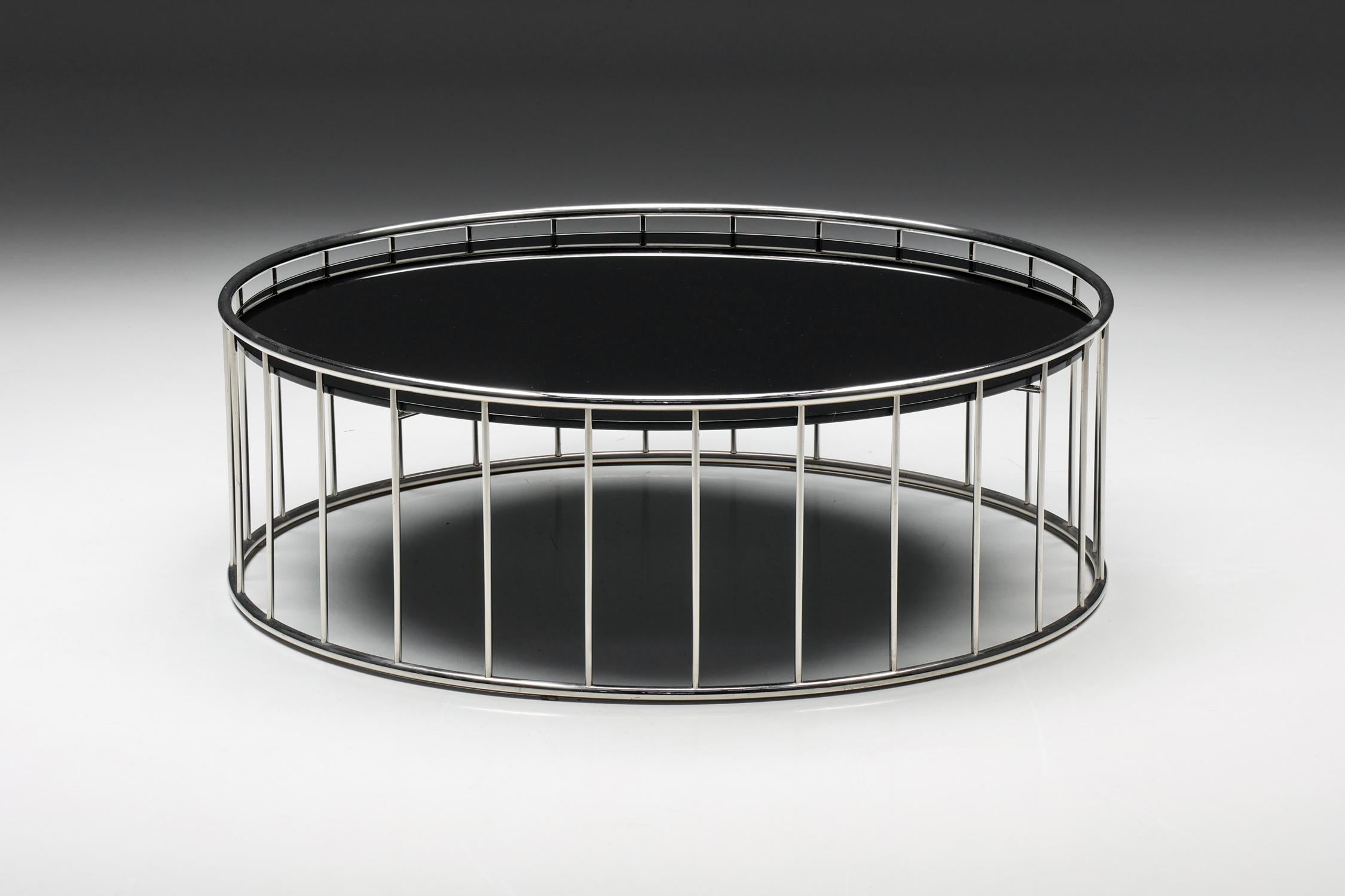 Caulfield coffee table by Rodolfo Dordoni for Minotti, Italy, 2003

This round coffee table, created by Rodolfo Dordoni for Minotti in 2003, is made of a metal frame and a glass surface. A series of columns support the glass top. The metal frame