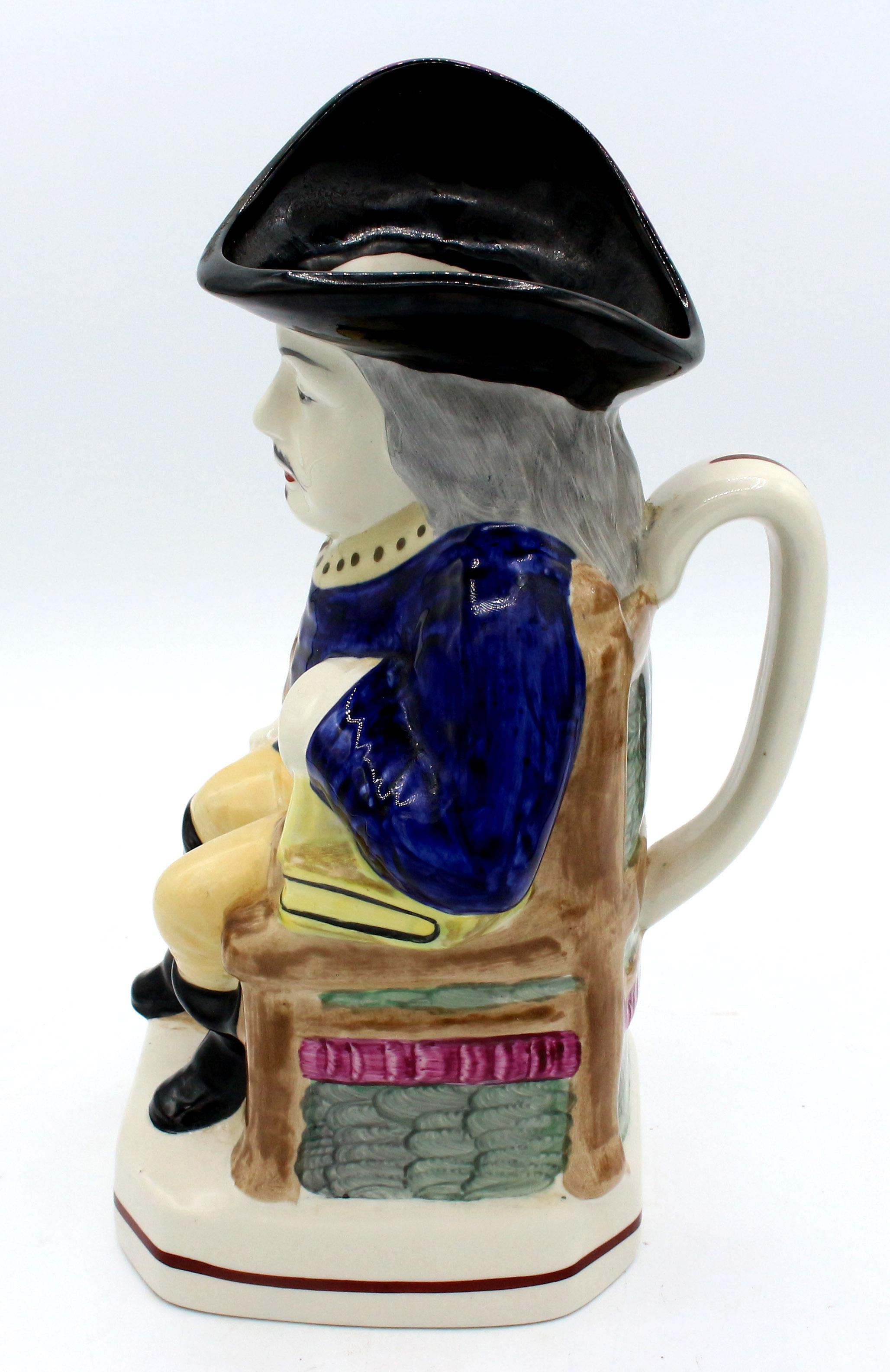 A Cavalier Toby Jug by William Kent, circa 1900, Staffordshire, England. The Cavalier in 17th century garb. Kent produced copies of period Staffordshire figures & originals. The pink feather edging the hat is a great touch. He is seated on a period