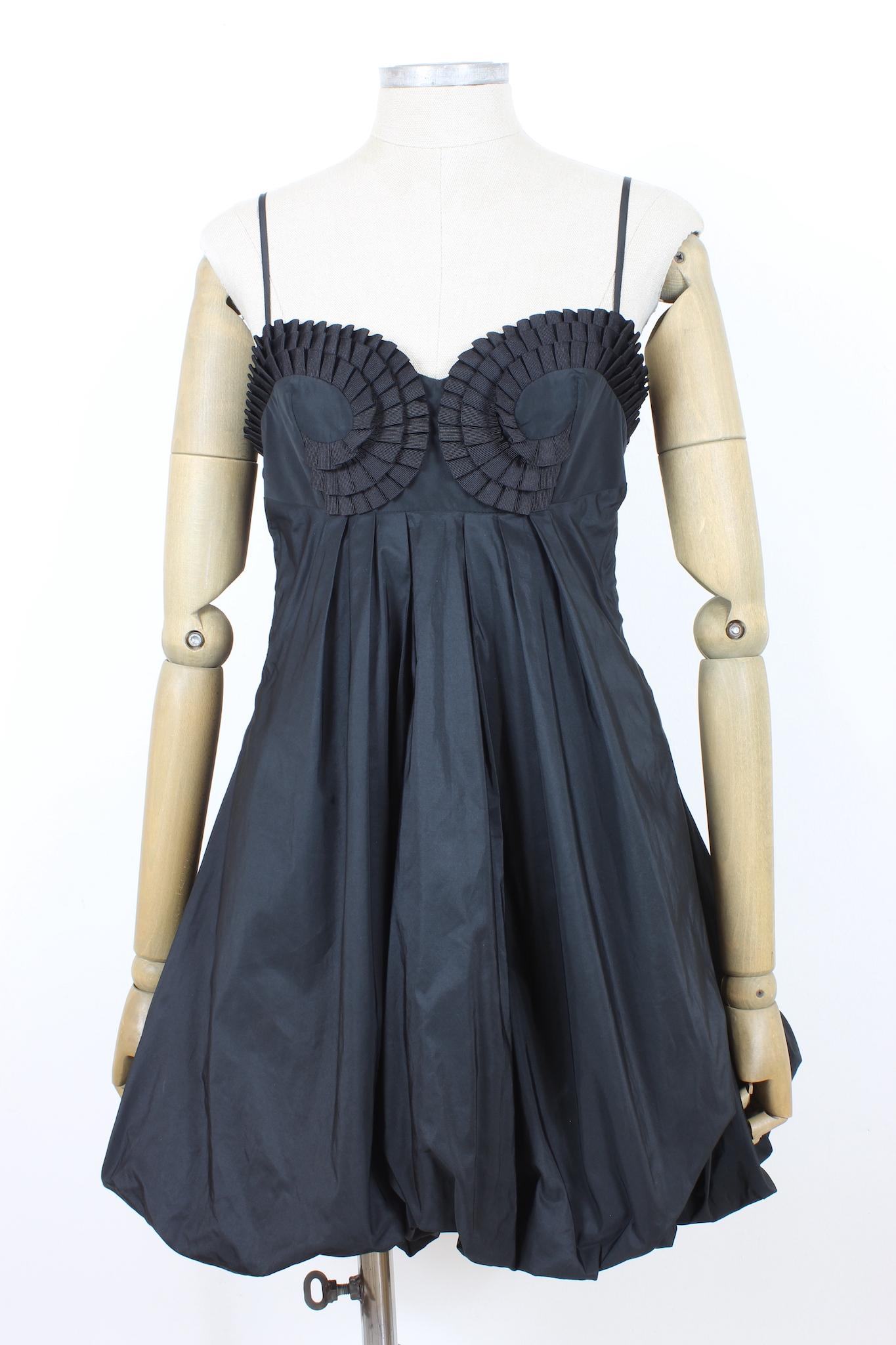 Cavalli 2000s black satin evening dress. Elegant dress suitable for a special event, it has a flared silhouette with a balloon skirt and ruffles on the chest. The length is above the knee, satin fabric. Made in Italy.

Size: 44 It 10 Us 12