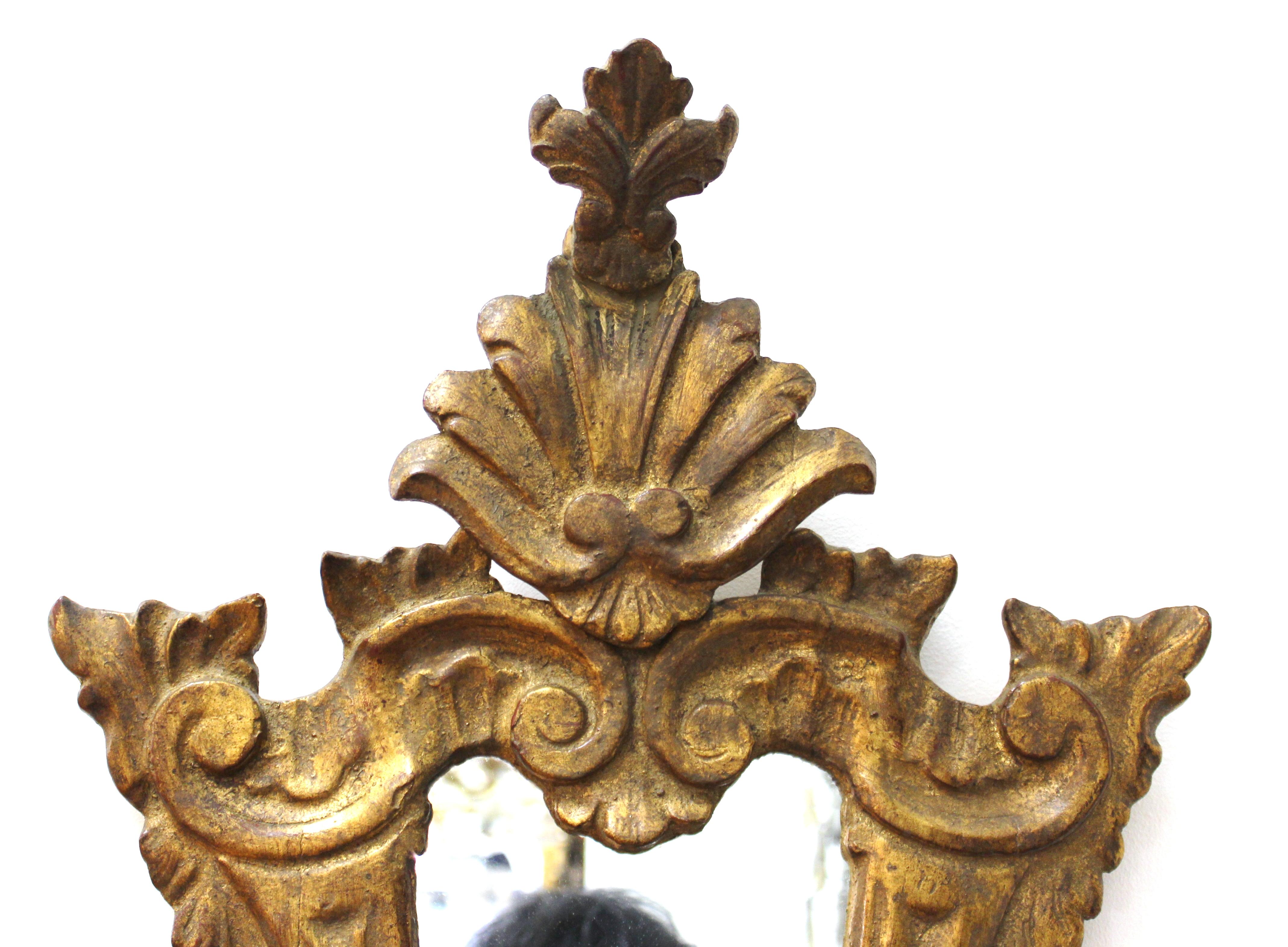 Cavallo Italian Baroque Revival style carved giltwood wall mirror. Makers label on the back. In great vintage condition with age-appropriate wear.