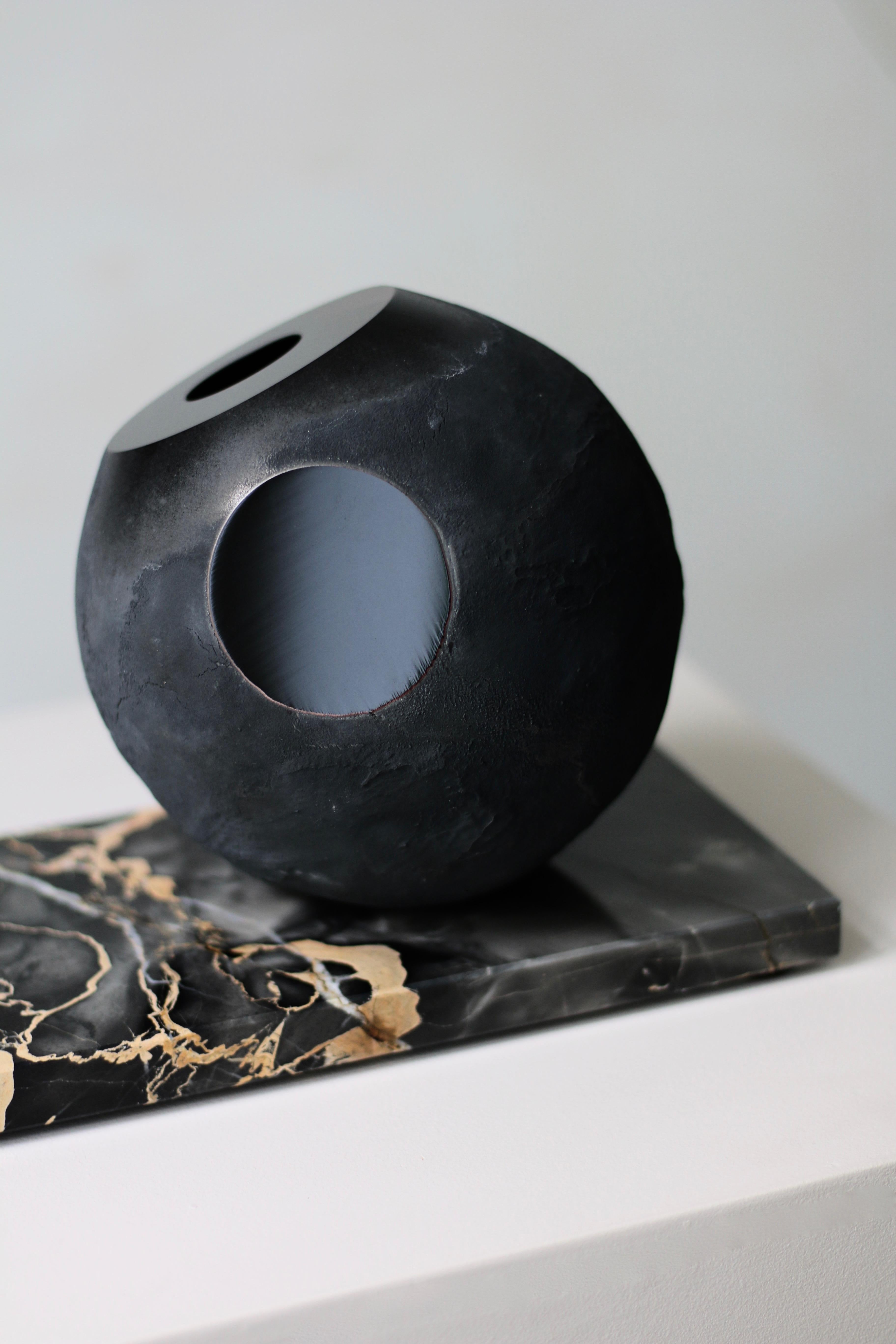 'Cave In Time' contemporary vase in mouth blown glass in black from collection ‘Mother Creation’. Contrasting matte-coated hallow sphere and intense black surfaces of highly polished glass.
Design, philosophy and development by Experimental.
A