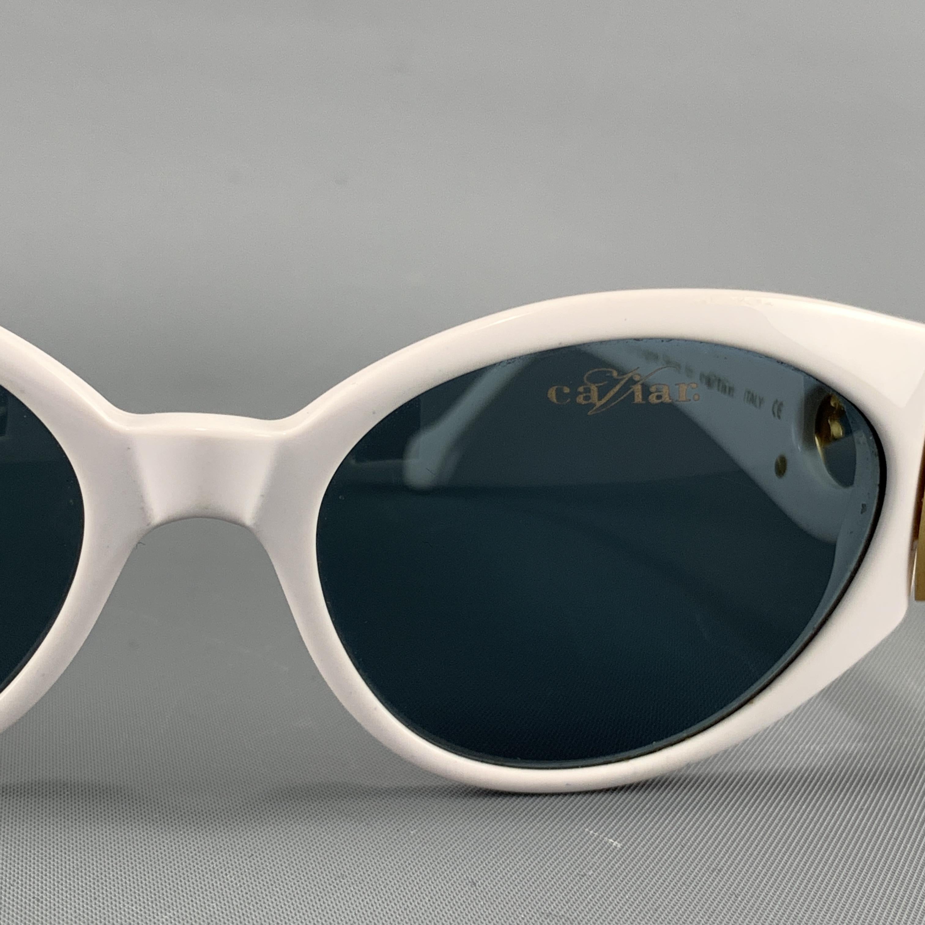 CAVIAR Champagne Series or the Swarovski series sunglasses come in a slight cat eye shape with yellow gold tone metal side adornment arms detailed with Swarovski crystals. Discolorations inside. As-is. Made in Italy.

Good Pre-Owned