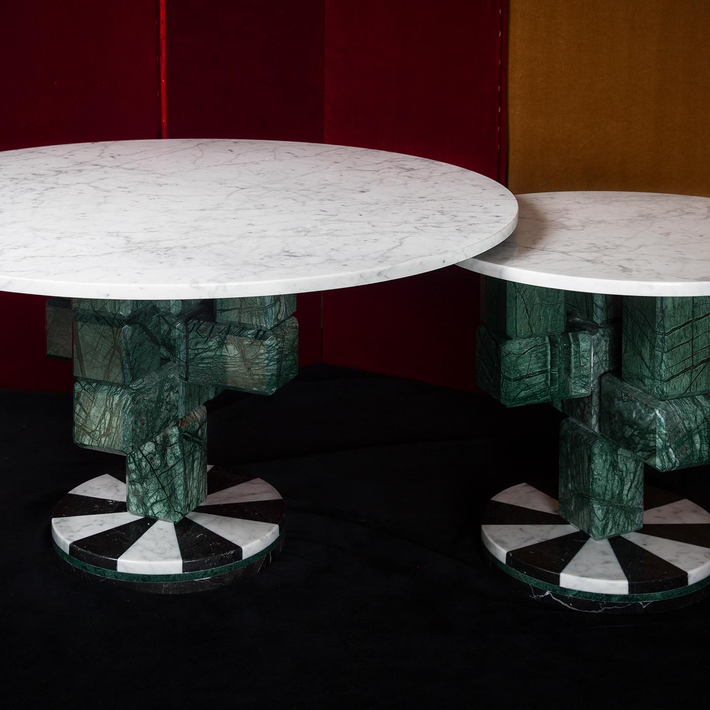 The unique design of this small coffee table will make a statement in a modern or eclectic interior, where it can be combined with other pieces in the same Caxus limited series. Resting on a striking round base of black and white marble, the stem is