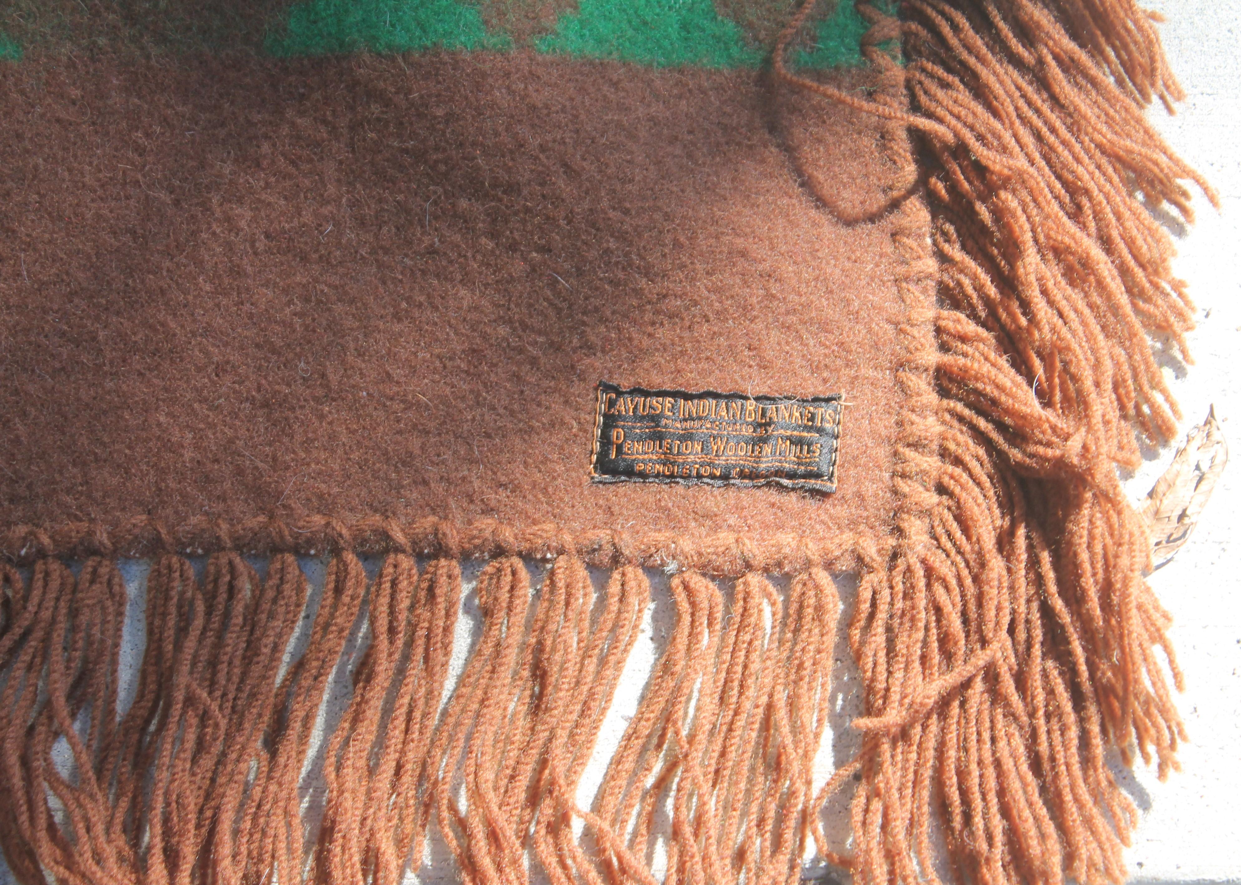 This early Pendleton black label Cayuse blanket with original fringe and label is in pristine condition. Such unusual colors and pattern on this blanket.
