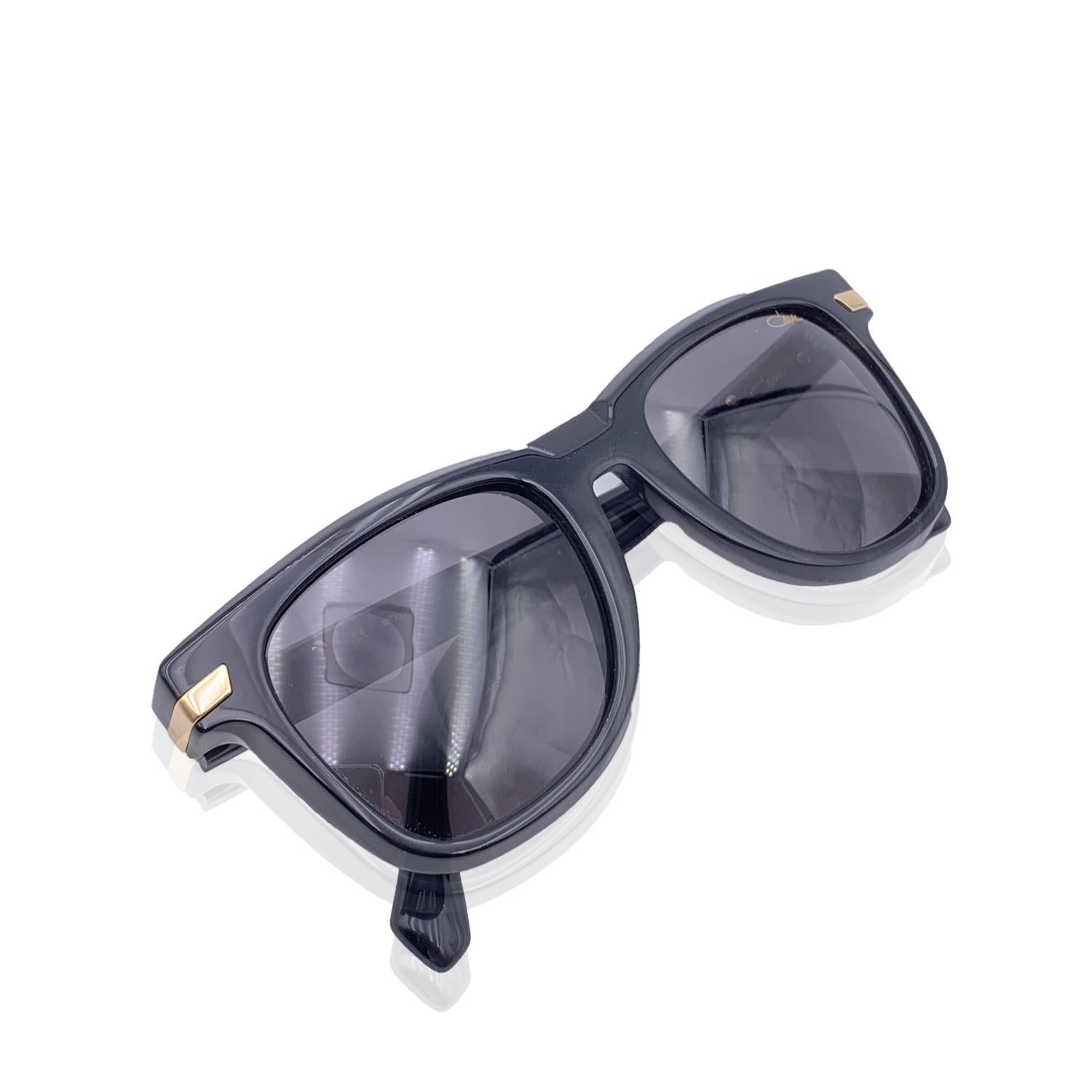 Beautiful sunglasses by Cazal, mod.8041, Col 001. Black acetate frame with gold metal accents on temples. Cazal logo on temples. Grey 100% UV protection lenses. Cazal signature on left lens. Made in Germany.

Details

MATERIAL: Acetate

COLOR:
