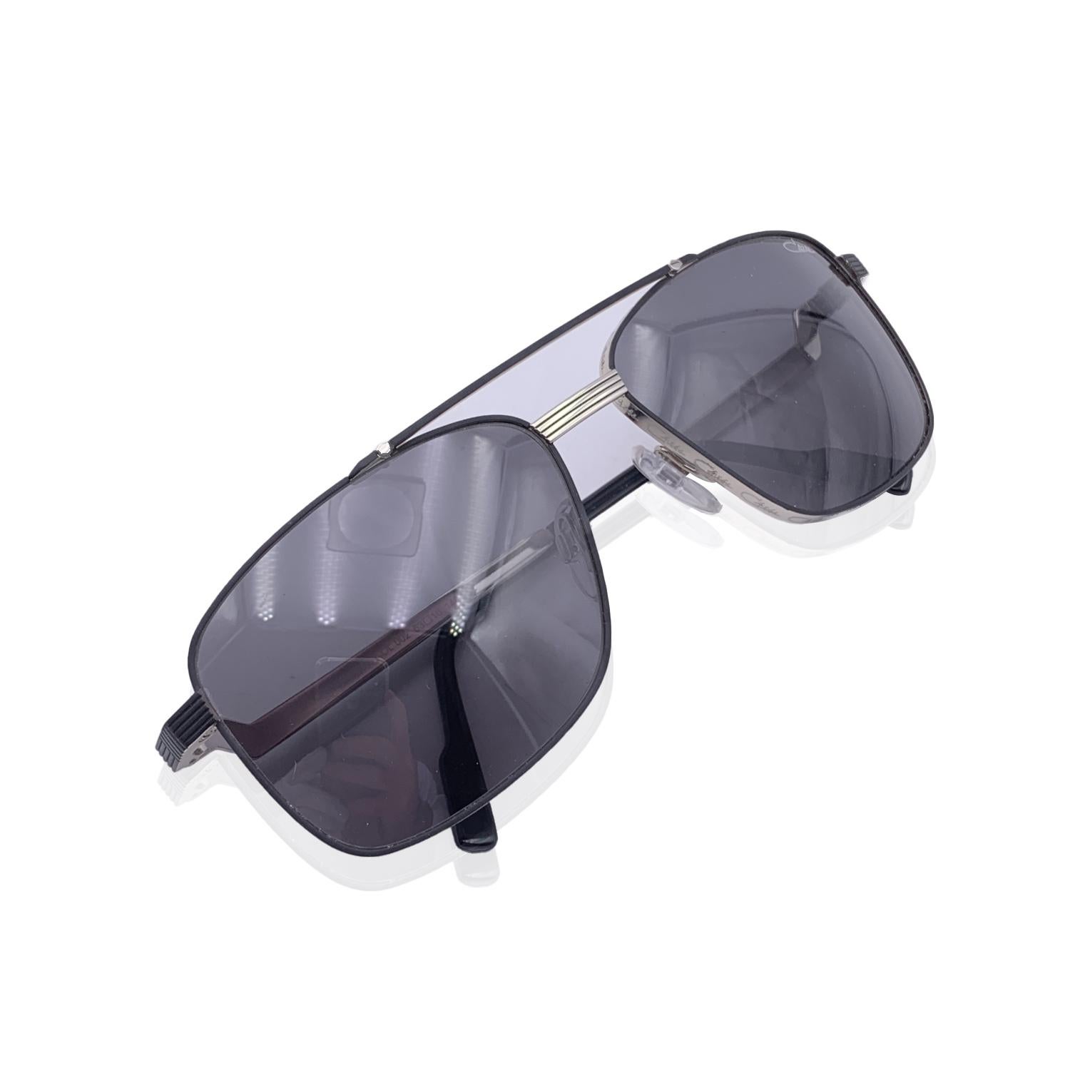 Beautiful sunglasses by Cazal, Mod. 9101 Col. 002. Silver metal and black metal frame, squared aviator design, with Cazal signatures embossed around the frame.Cazal logo on temples. Grey 100% UV protection lenses. Made in