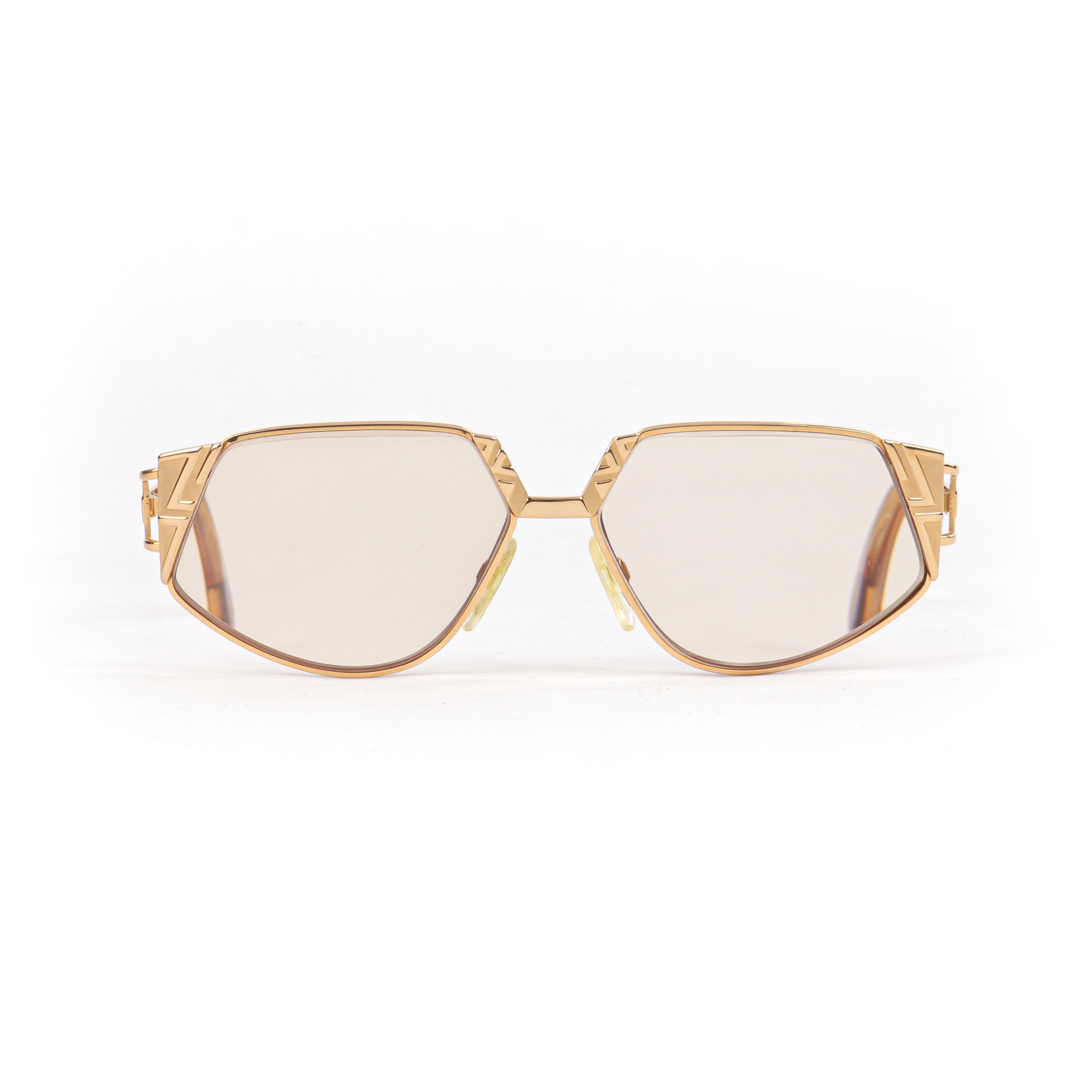 CAZAL c.1990’s Gold Tortoise Geometric MOD 238 Pentagonal Cat Eye Sunglasses 
 
Brand / Manufacturer: CAZAL
Circa: 1990’s
Style: Cat eye
Color(s): Shades of gold and brown
Lined: No
Unmarked Fabric Content (feel of): Glass lens, metal frame,
