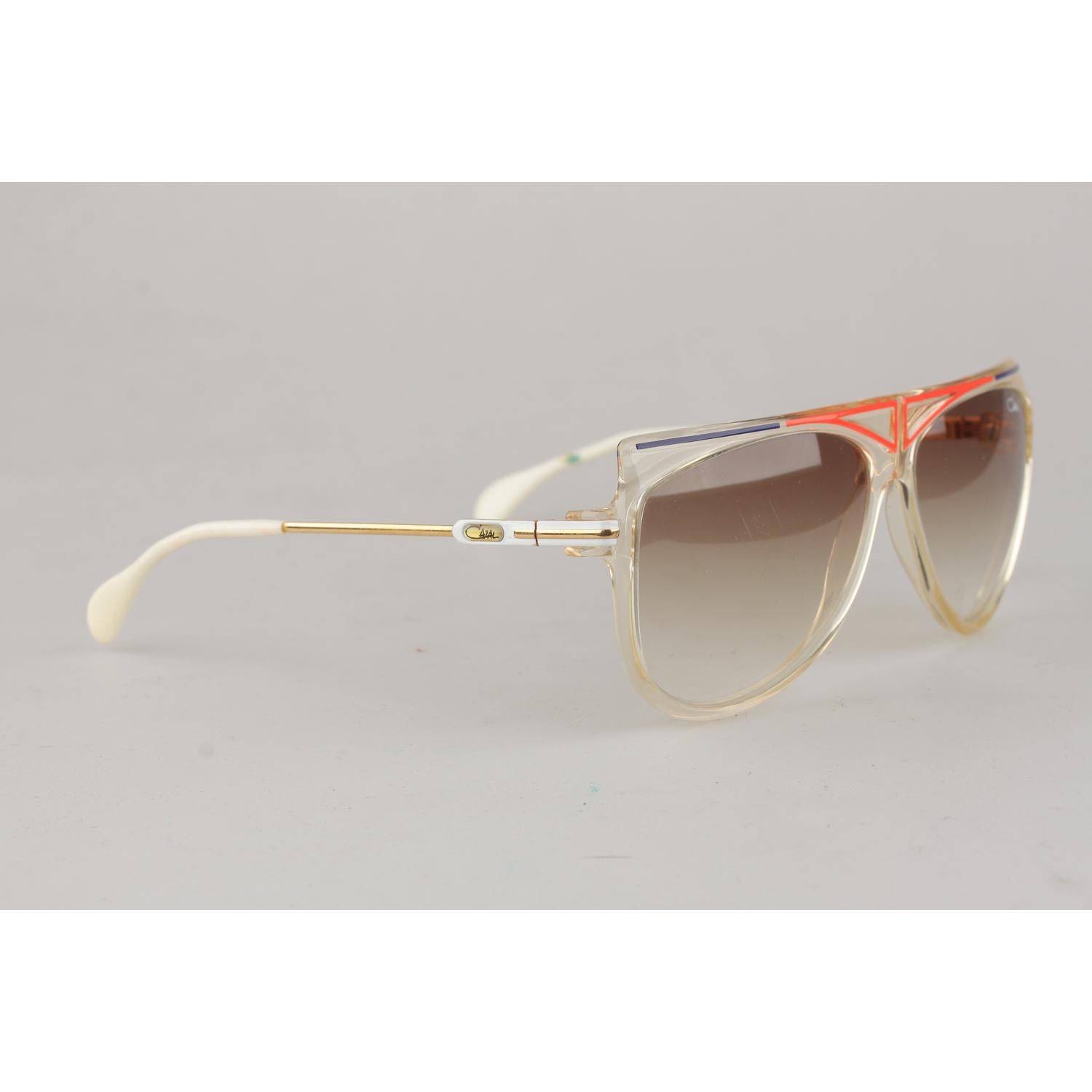 CAZAL Rare squared style vintage sunglasses from the end of the 1970s, Made in West Germany - Acetate semi transparent frame, with red and blue finish on the front. Original Cazal gradient light brown lenses. Black and yellow Cazal classic logo on