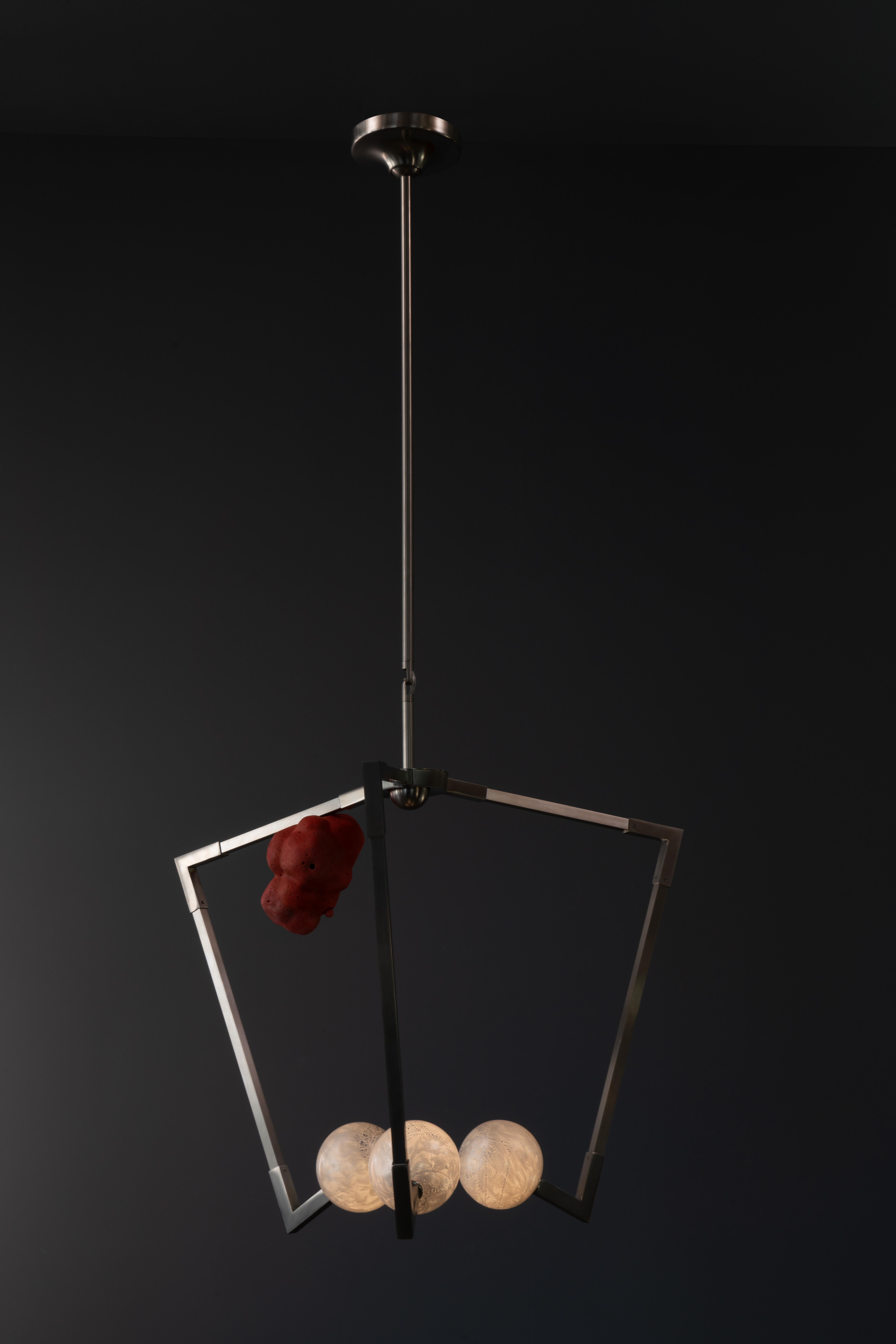 The MED.V1 Luminaire is a genre-defying mid size fixture with 3 radiating brass arms, hanging at a slight tilt, like a soul-surfer riding a wave. 

Gently balancing on the arms are 1 or 2 coral inspired decorative cast porcelain shapes called