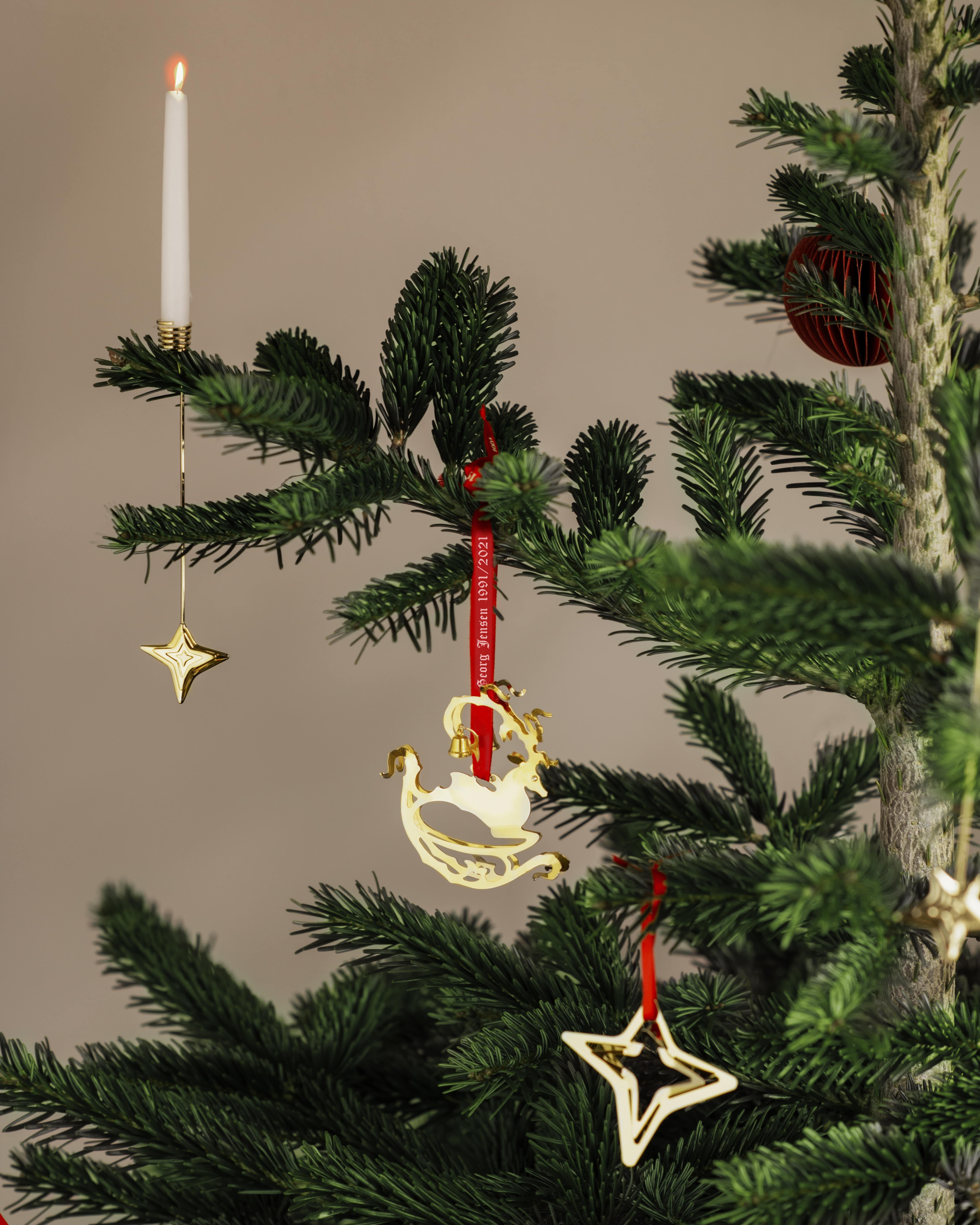 A special mobile re-released to celebrate thirty years of Georg Jensen Christmas Collectibles; this contemporary version of a traditional Christmas deer, complete with bells on its antlers, would be a beautiful addition to any collection of