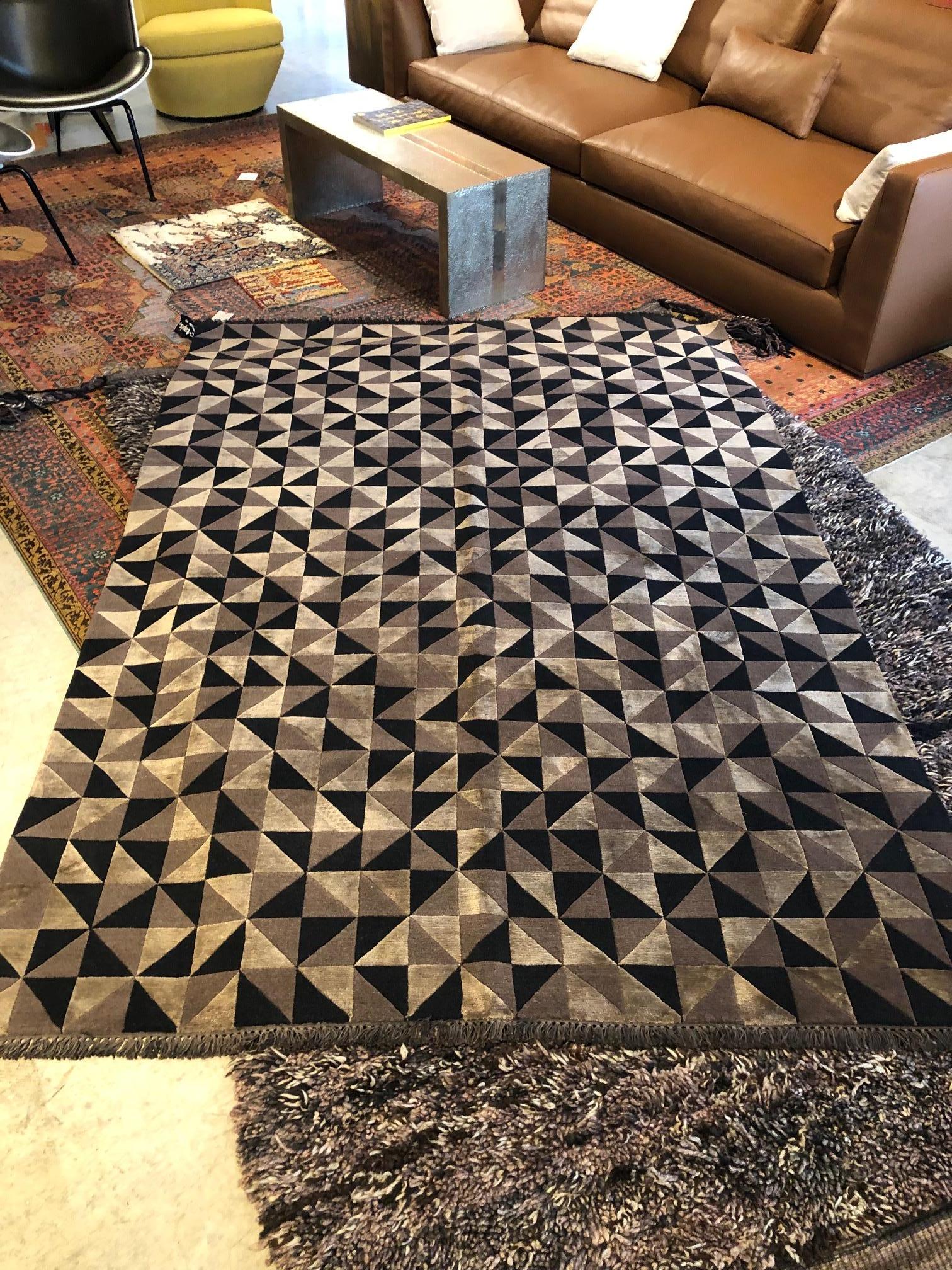 cc-tapis Mid Mod Area Rug 

Hand-knotted wool and silk area rug is made in Nepal. Black wool, bronze wool, and bronze silk geometric pattern has hand scissoring details to further accentuate the geometric pattern which is reminiscent of Italian tile