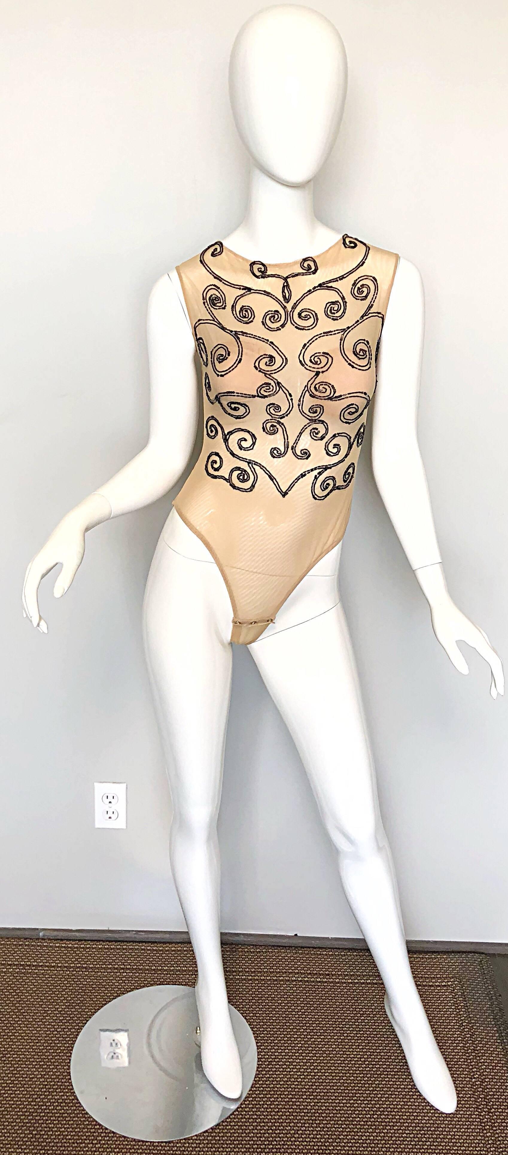 Sexy 1990s C.D GREENE Couture never worn nude and black beaded sheer bodysuit! Features a double layered nude mesh with thousands of hand-sewn black seed beads throughout the front. Hidden zipper up the back with hook-and-eye closure. Built-in nude