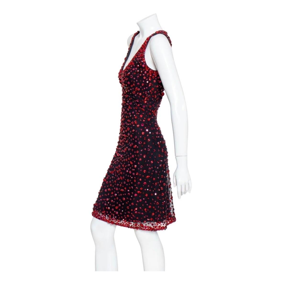 Red crystal dress by CD Greene
Black background
Sleeveless
Allover red crystals
Mesh topper
A-line bodycon silhouette
Scoop neckline
Back cutout with strap
Hook and eye closure on neck and back
Above-knee length
Fabric Composition: unknown; likely a