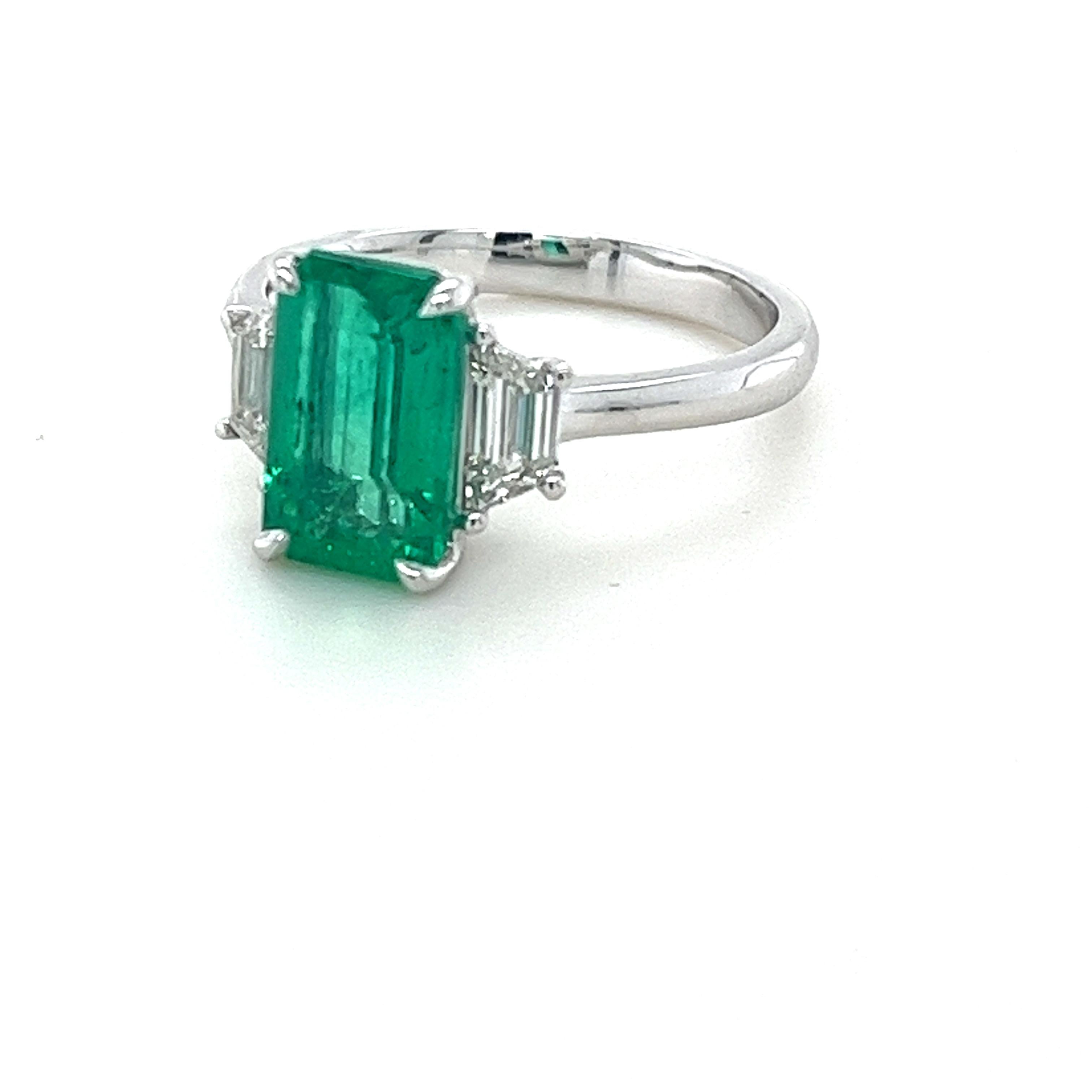 CDC Certified Emerald Cut Colombian Emerald weighing 2.12 carats
Minor clarity enhancement
Measuring (10.20x6.25x4.30) mm
Diamond quality G-Si1
Trapezoid diamonds weighing .56 carats
Set in platinum ring
5.63 grams
