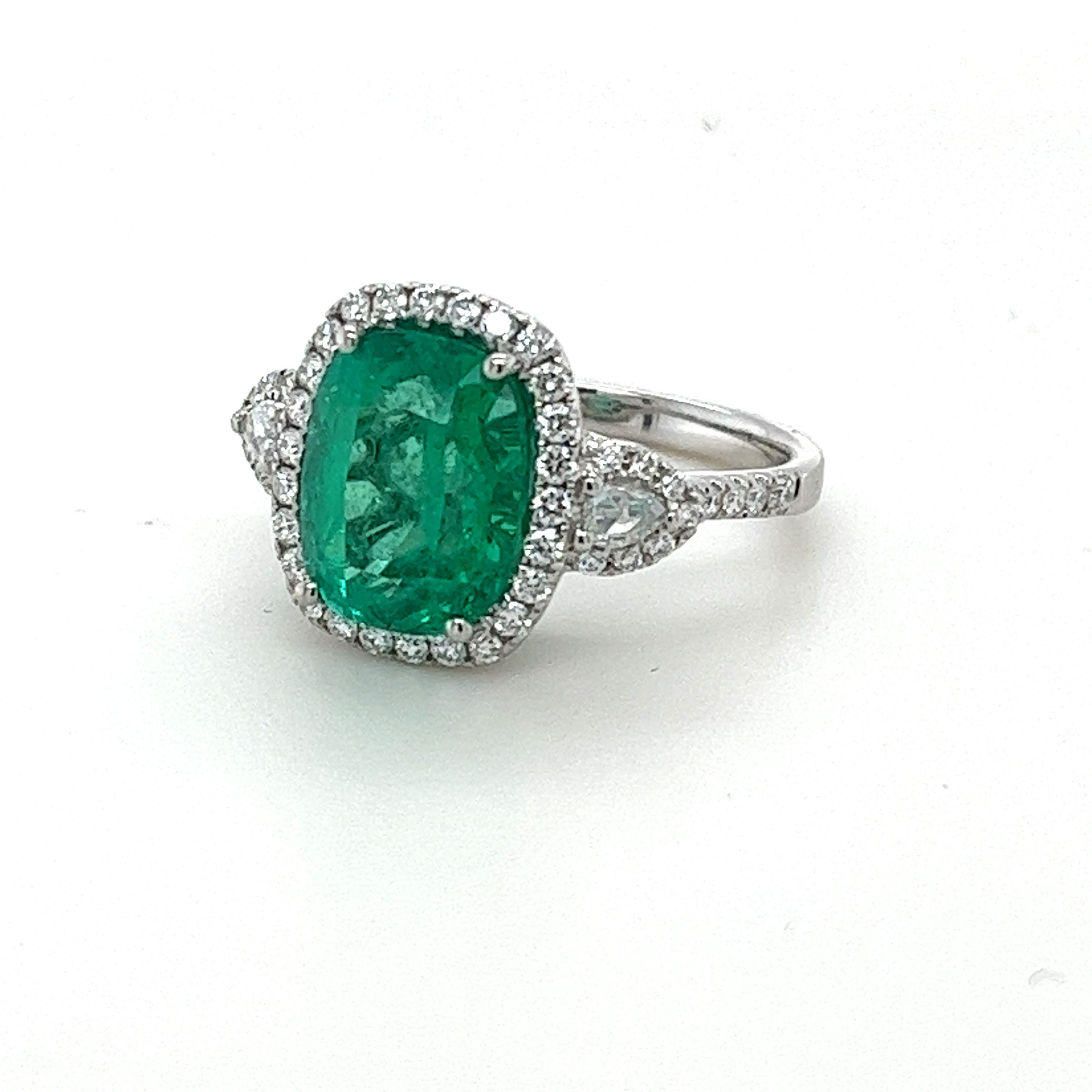 CDC certified cushion Colombian Emerald weighing 4.17 carats
Measuring (11.04x8.94x6.81) mm
Diamonds are GH-Si quality
Round diamonds weigh .51 carats
Rose cut diamonds weigh .12 carats
Set in 18 karat white gold ring
5.38 grams