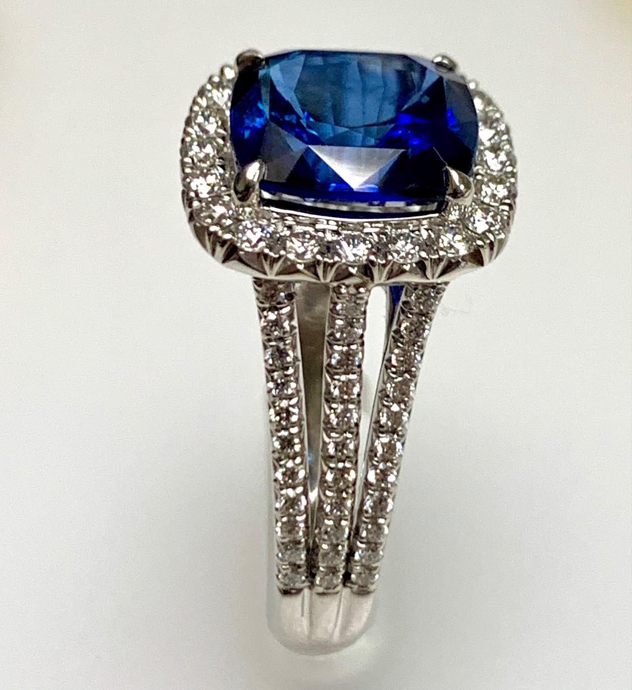 4.11 Carat Cushopn shape Royal blue sapphire certified CDC lab set in Platinum ring with 0.74 carat  Diamonds surronded and on the shanks .