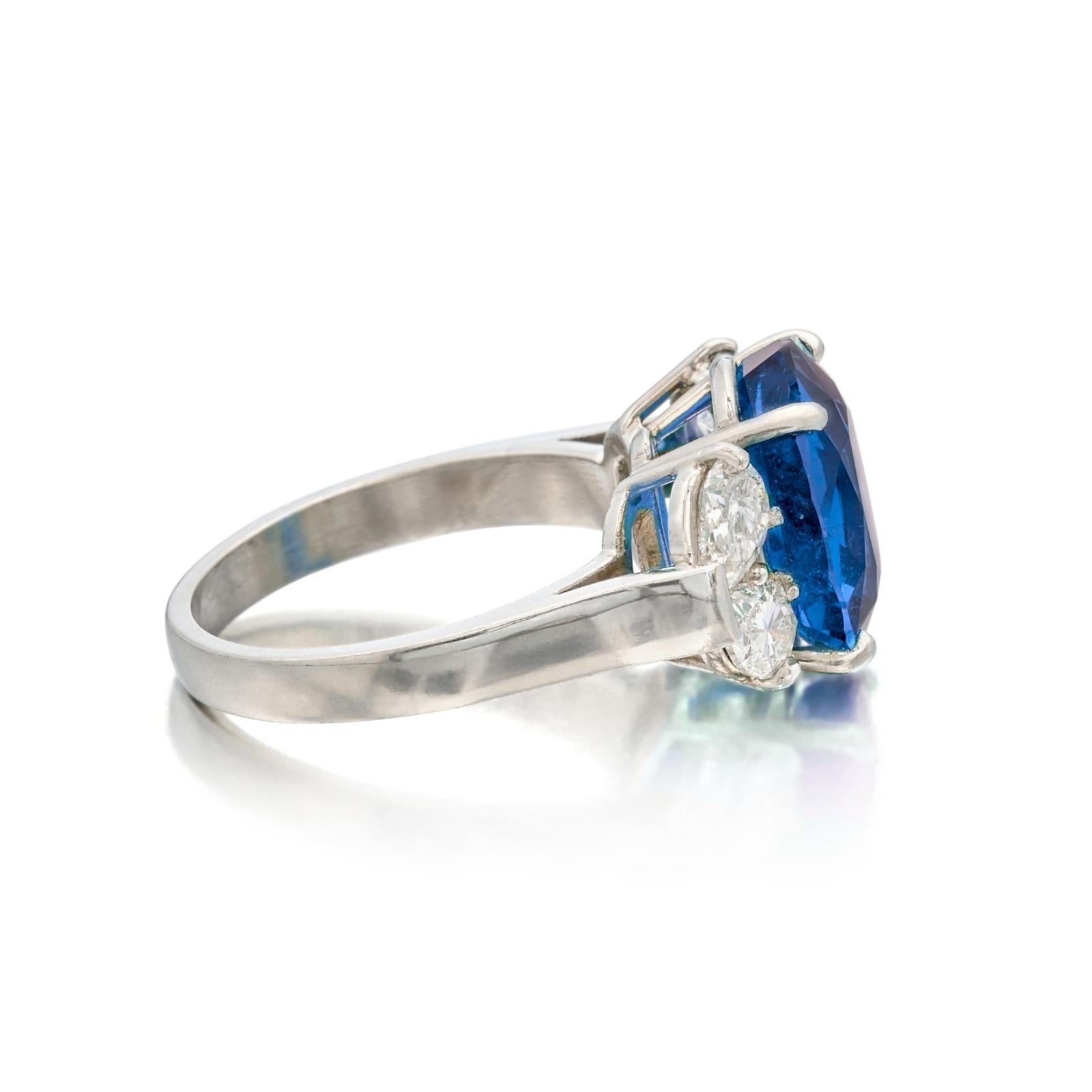 Centering a oval-shaped emerald, flanked by 4 pear-shaped diamonds

emerald weighing 9.78 carats
Size 6
Platinum
Accompanied by C. Dunaigre report  stating that the emerald is of  Ceylon origin, with cornflower blue color
